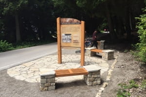 Mackinac Island Native American Cultural History Trail No. 6, with interpretive sign and bicyclist. Mackinac Island Native American Cultural History Trail No. 6, with interpretive sign and bicyclist.