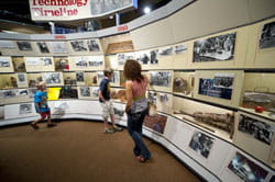 Mother and her two sons viewing the Timeline exhibit at the Michigan Iron Industry Museum.