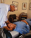 Chiropractor adjusting man's neck