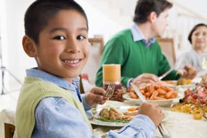 A boy with family eating fish