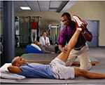 Therapist working on patient leg