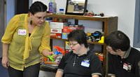 Eva Jenson of DAKC working with RICC members Eva Jenson of DAKC working with RICC members