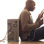 Man sitting next to a computer