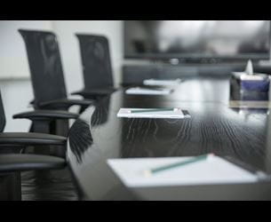 Empty boardroom with notepads