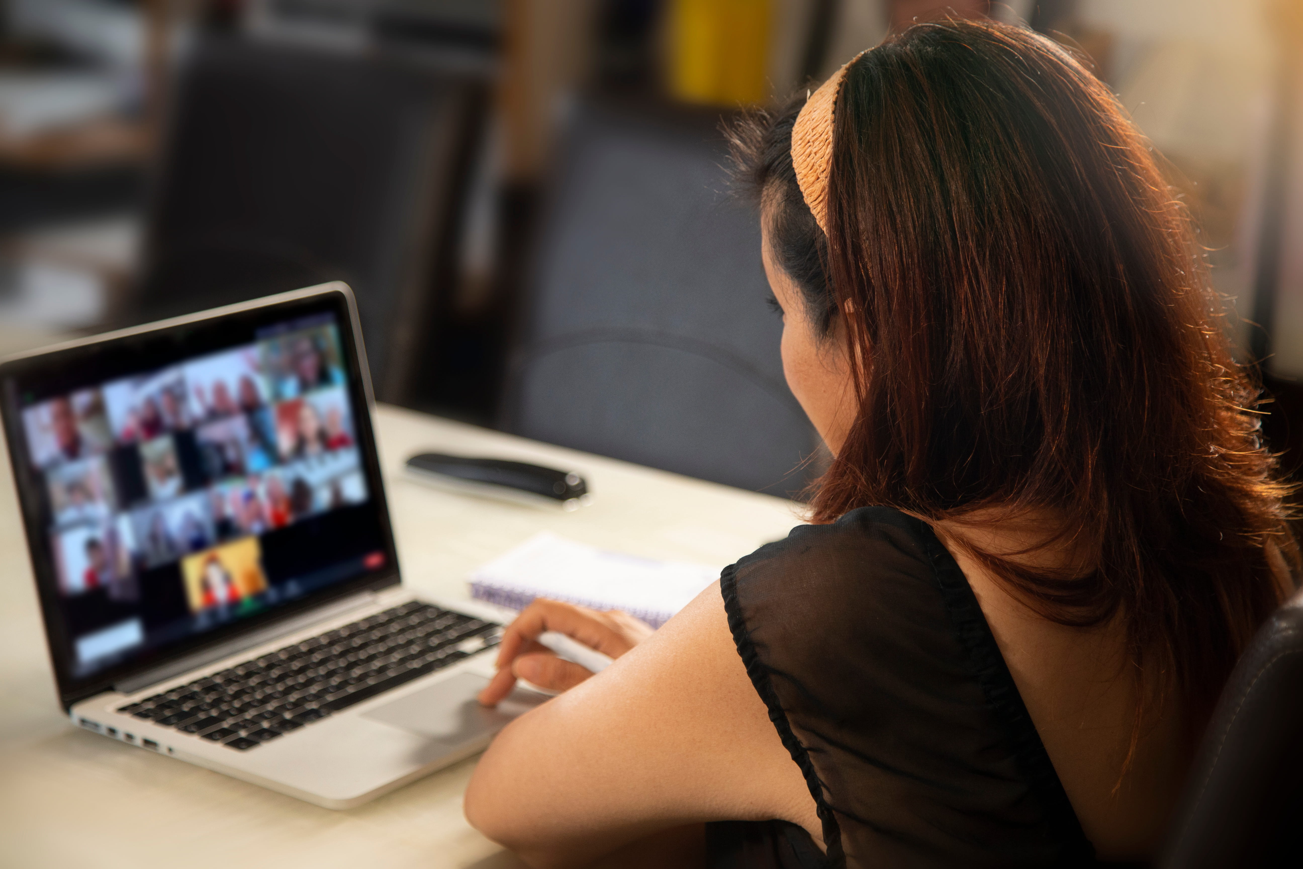 Young woman on a virtual meeting with coworkers