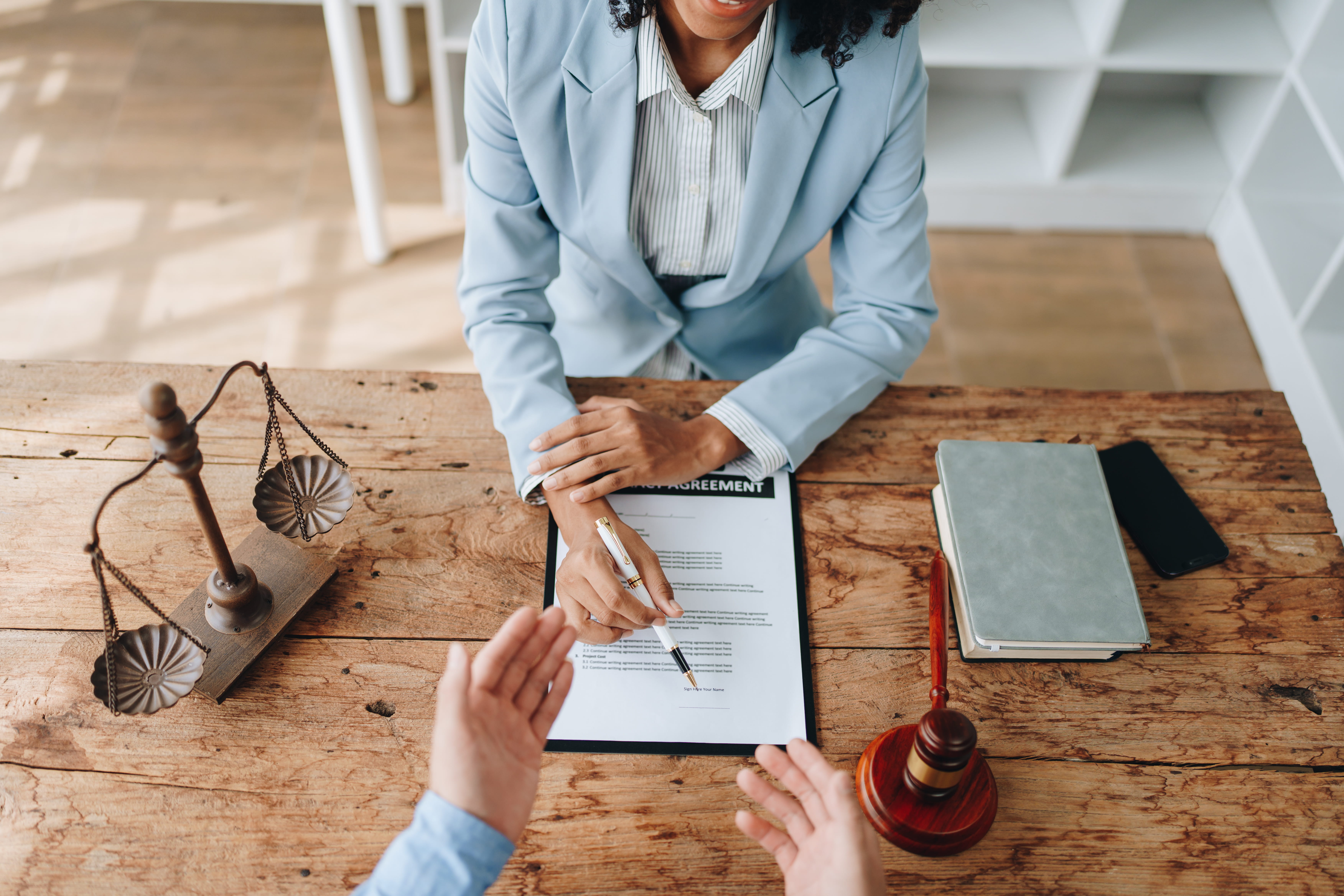African american attorney discussing agreement at law firm office