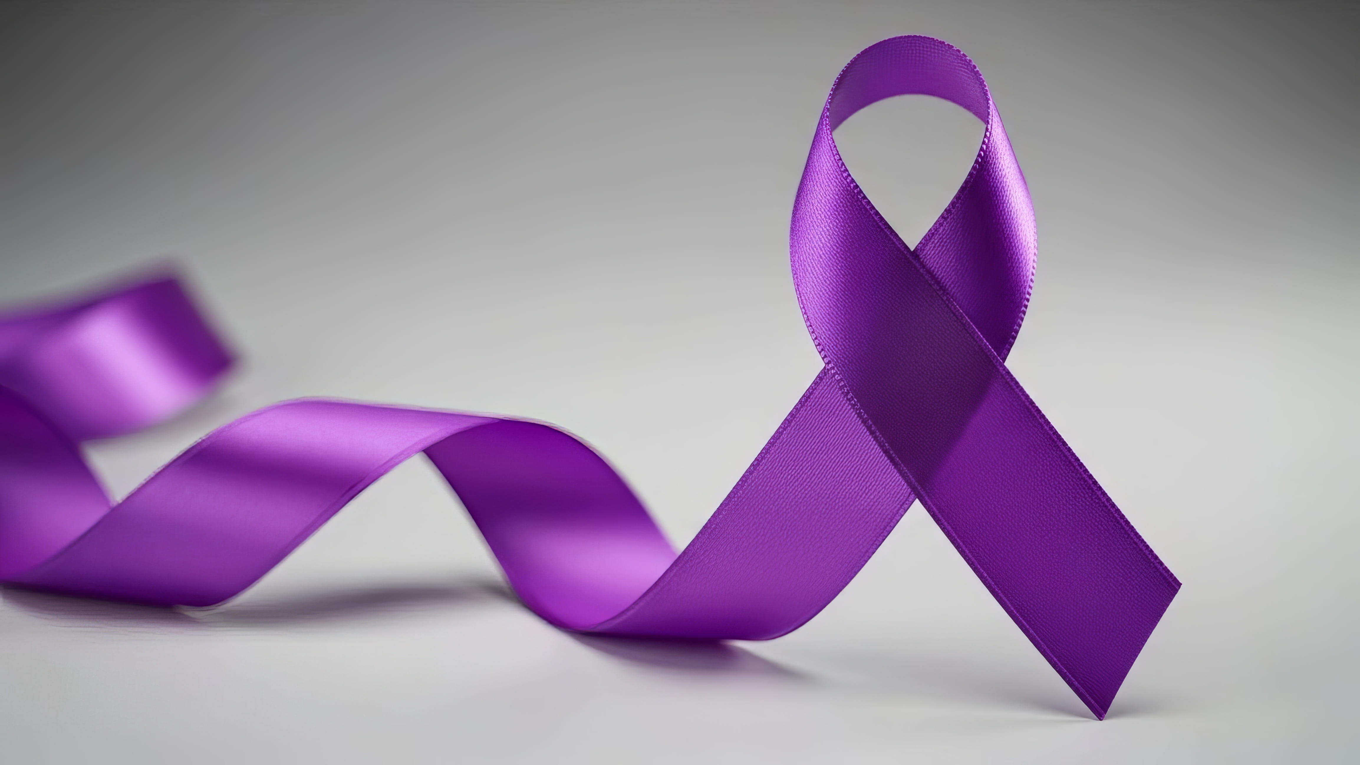 A bright purple elder abuse awareness ribbon curves across a plain gray background with soft lighting
