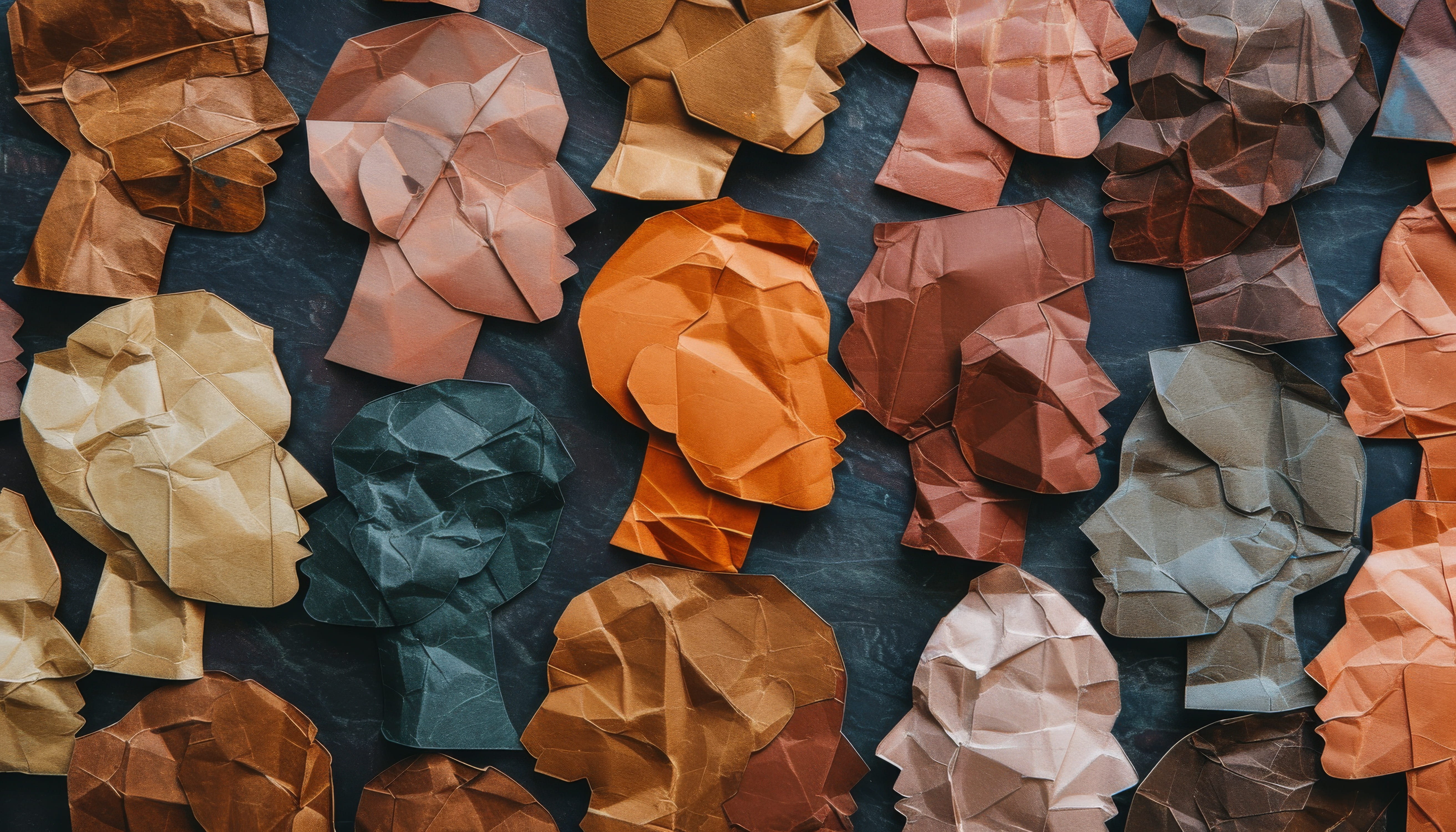 Overcoming unconscious bias; diverse paper cut outs of many people of different shades