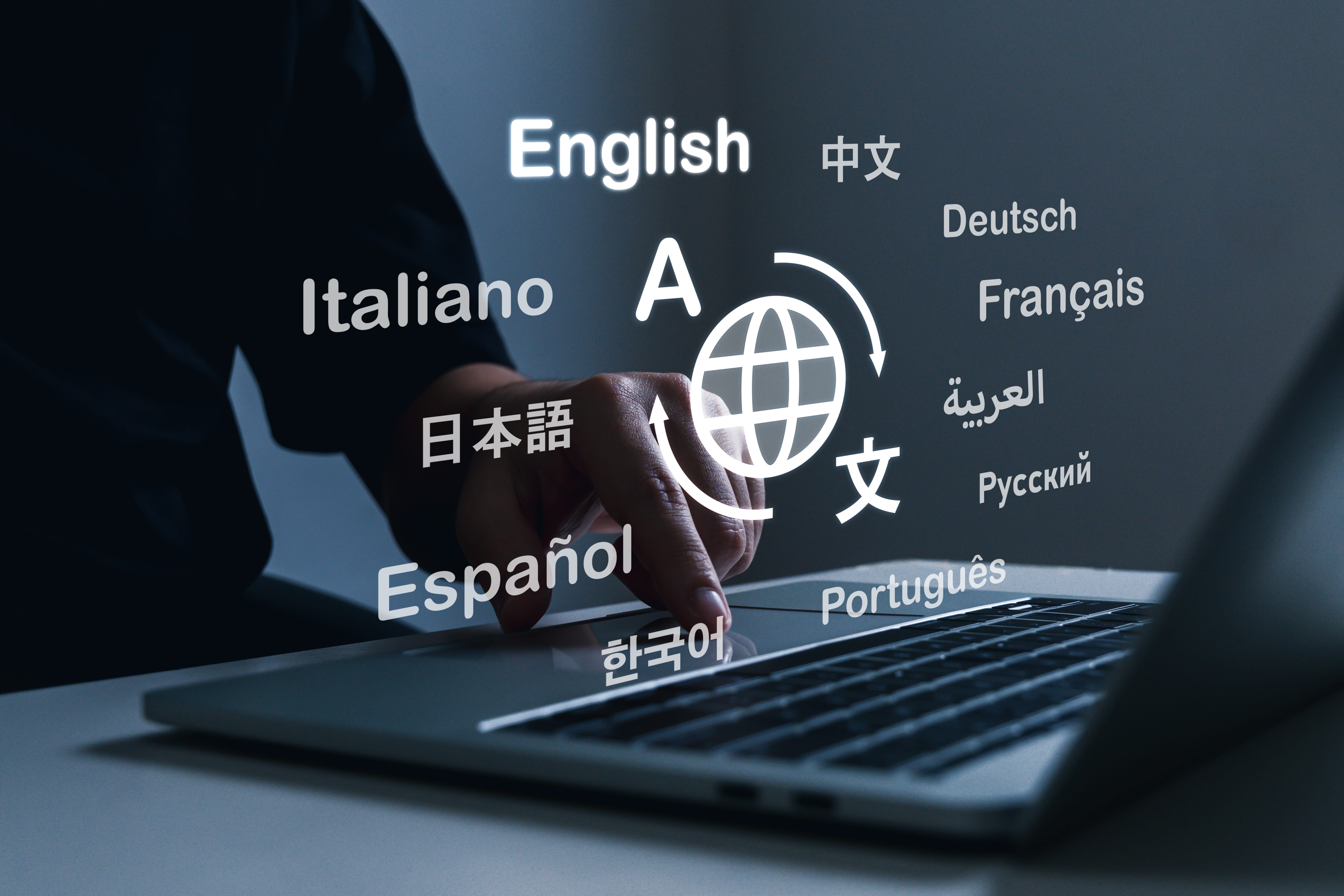Person working with virtual translation application software on laptop computer.