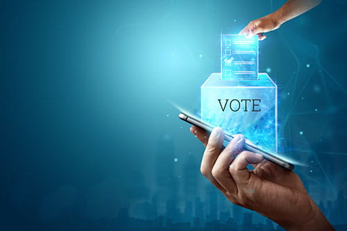 Hand with a hologram ballot and a box for Internet voting in a mobile phone on a blue background