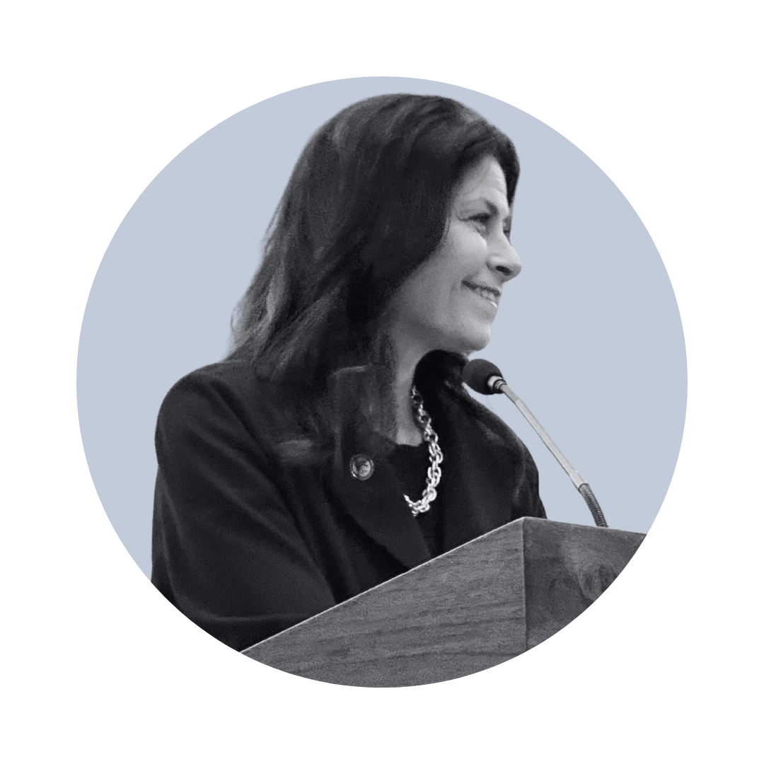 Dana Nessel headshot, standing at a podium.