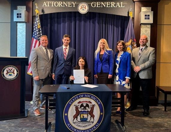 Michigan Attorney General Dana Nessel signs Senate Bill 602 into law as acting governor. Nessel was joined by members of the Michigan Realtors, representatives of the Department of Attorney General, and her son.