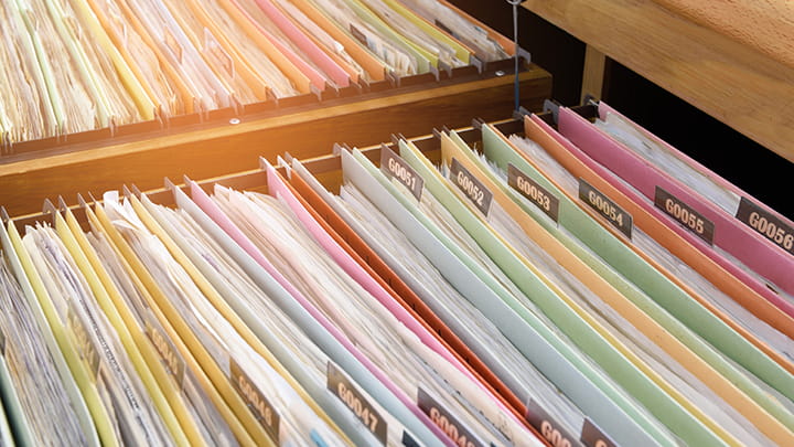 Documents stored and displayed in a side-by-side filing cabinet.
