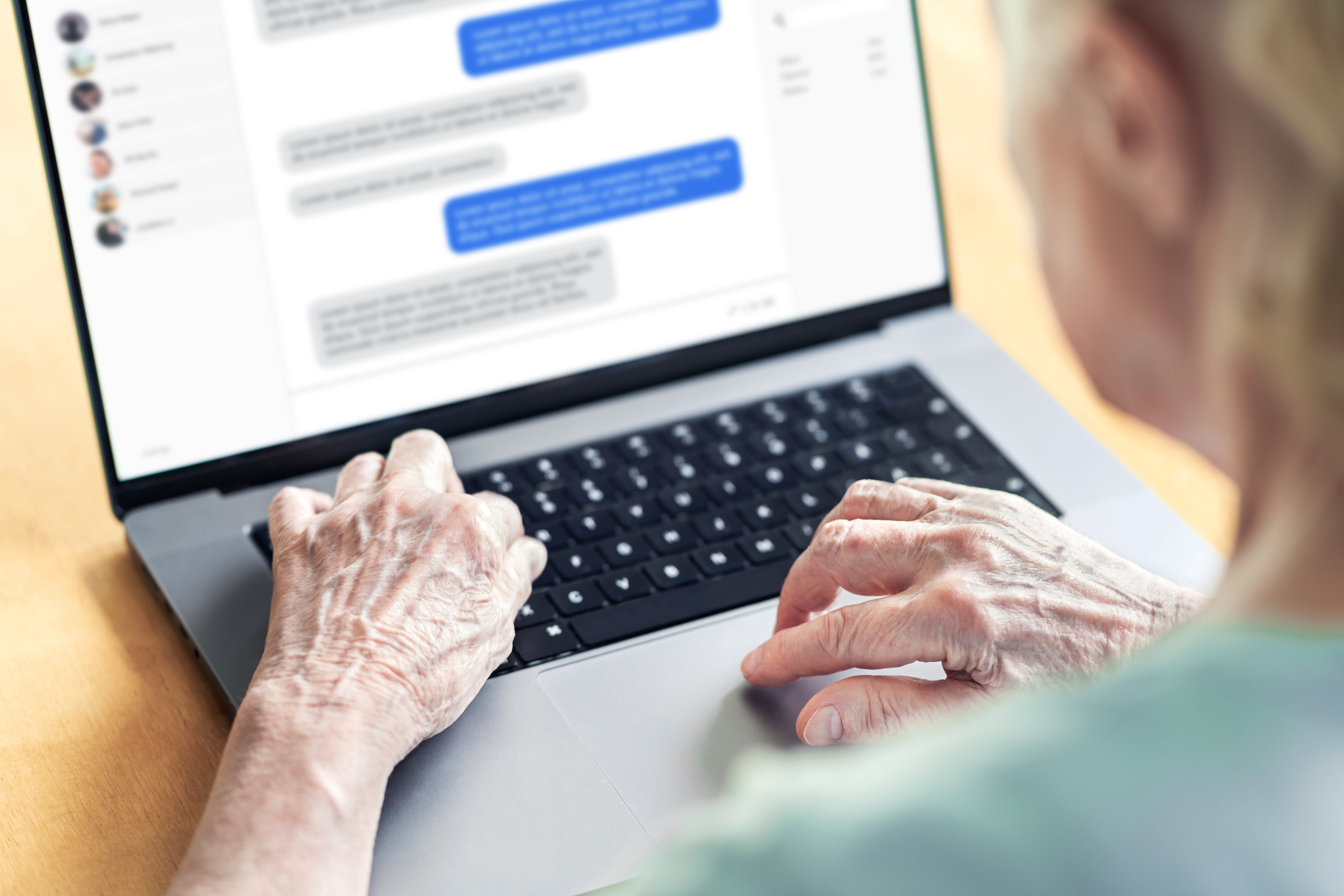 Chat messages in laptop of an old woma