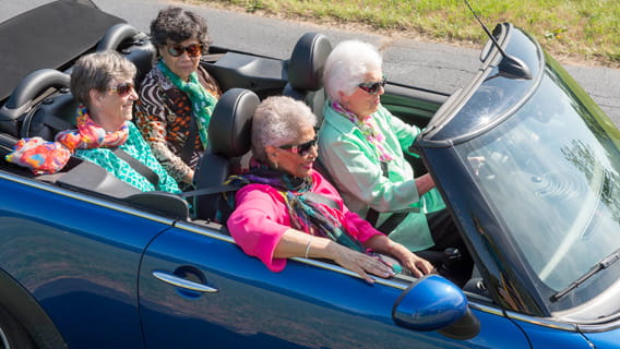 Seniors driving a convertible