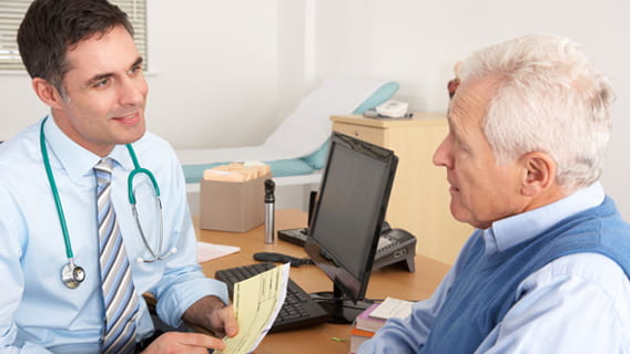 Elderly man talking with doctor