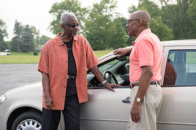 Older men near a vehicle