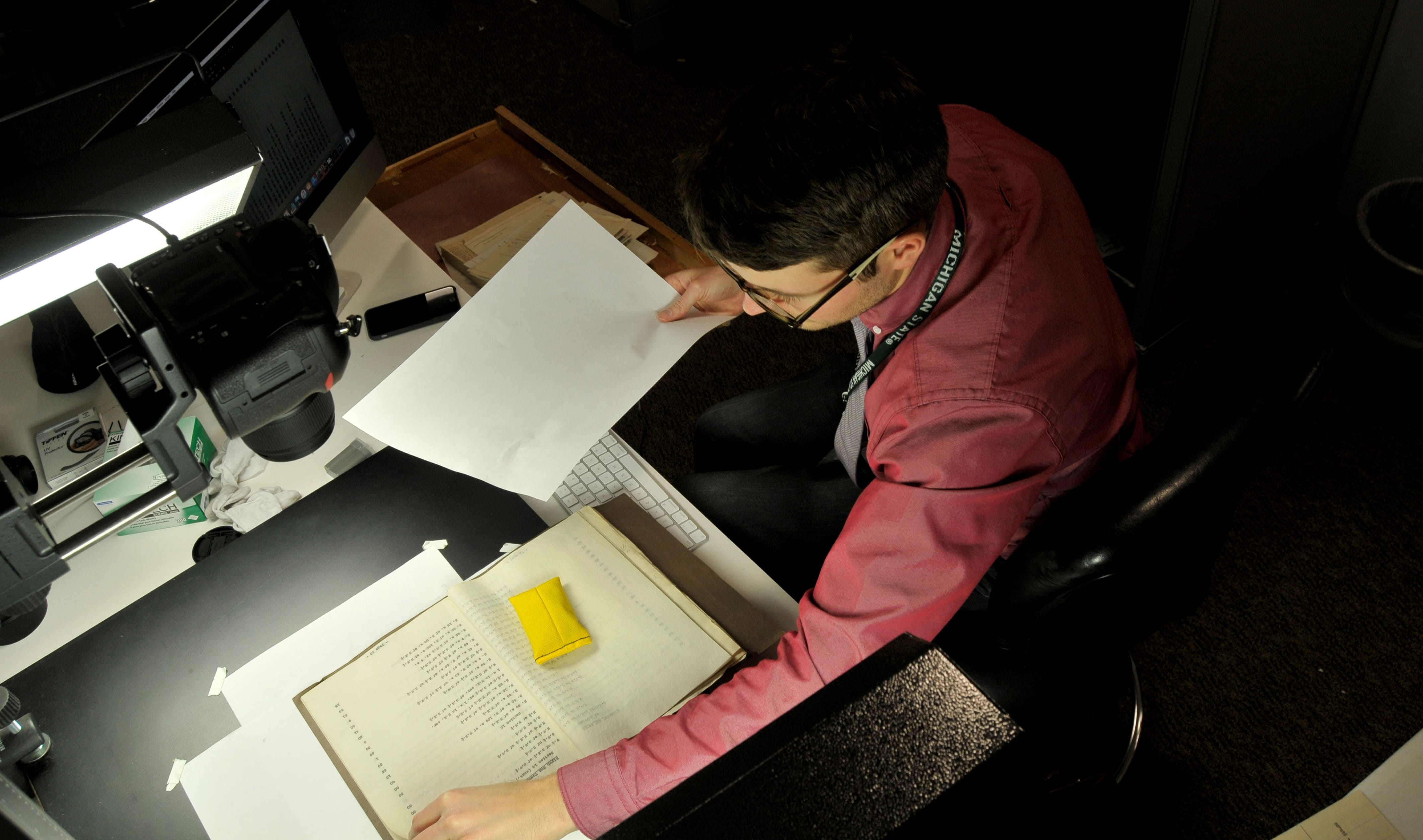 Archivist Jason Schultz digitization fragile inter-county drain documents.