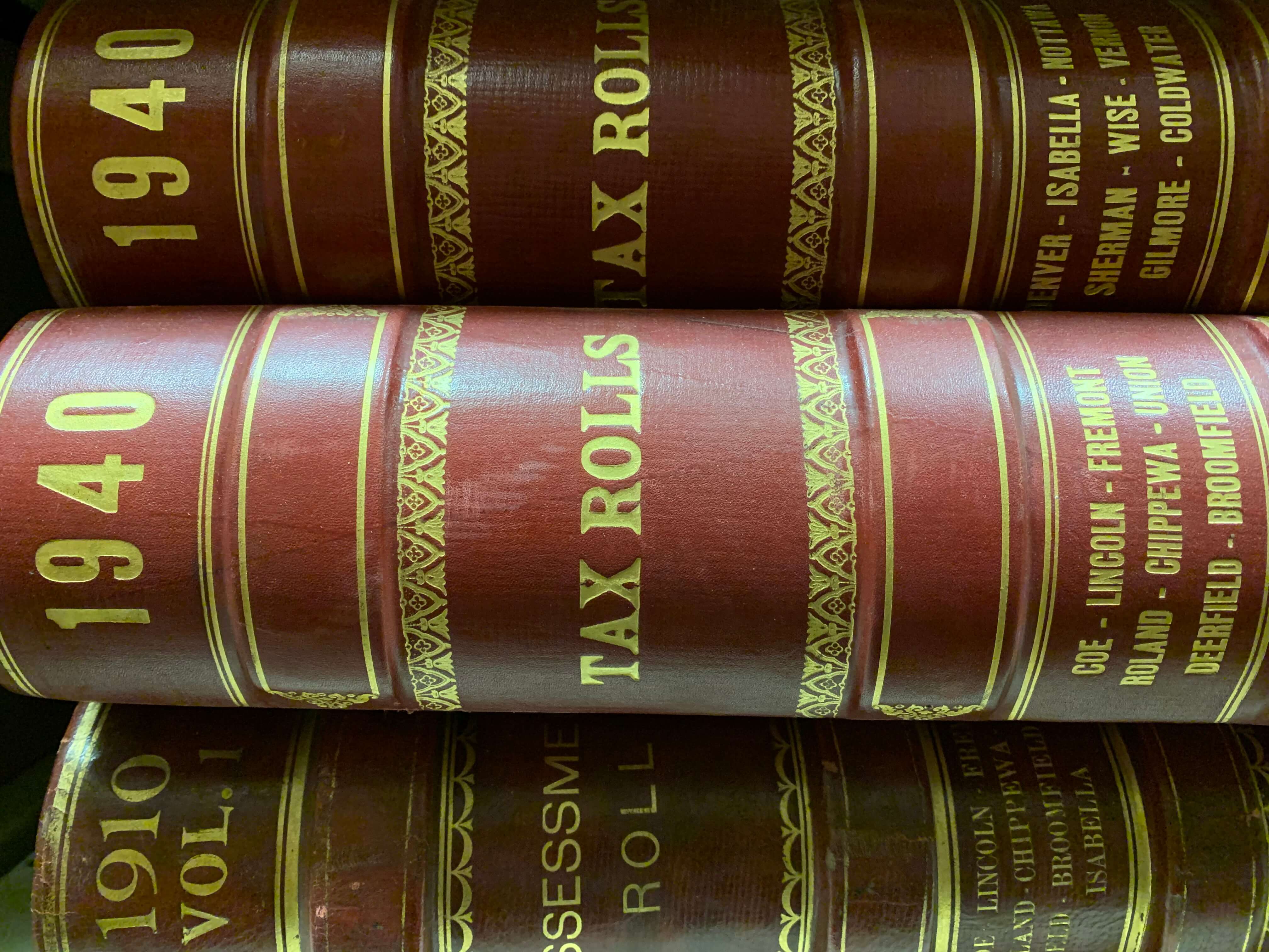 Volumes lying flat that read "1940 Tax Rolls."