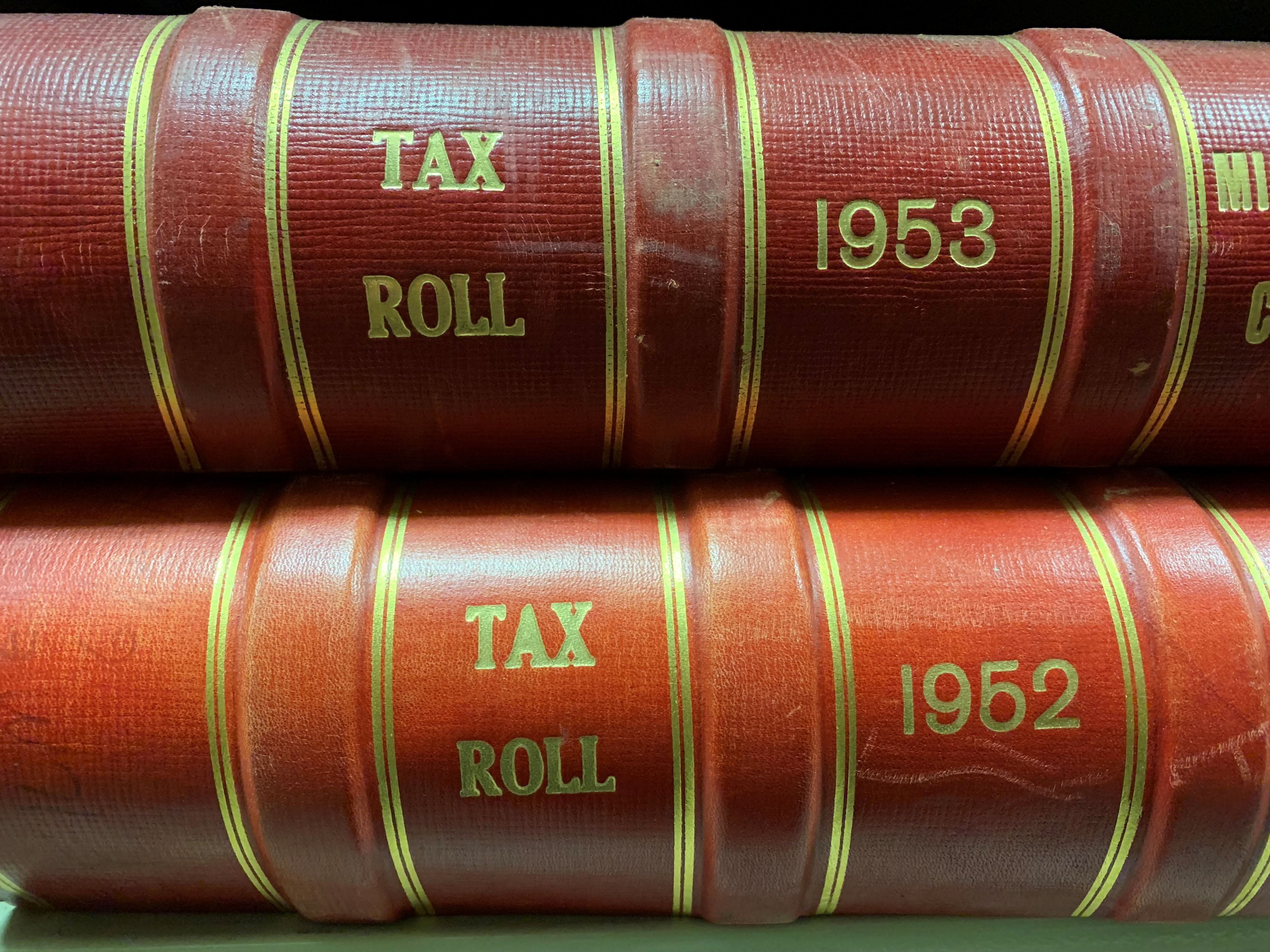 Volumes lying flat that read "Tax Rolls 1952" and "Tax Rolls 1953."