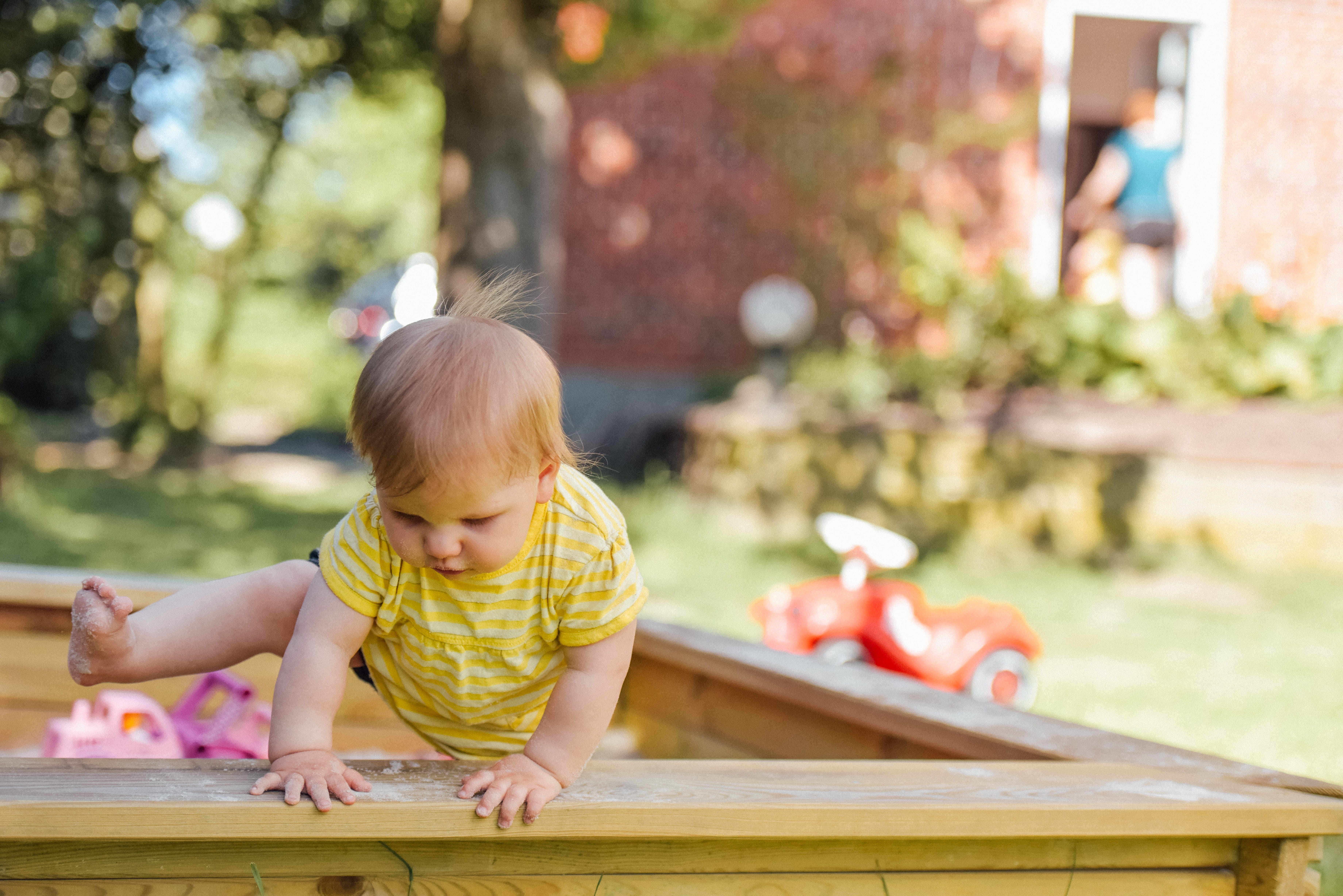 Photo of baby playing in sandbox