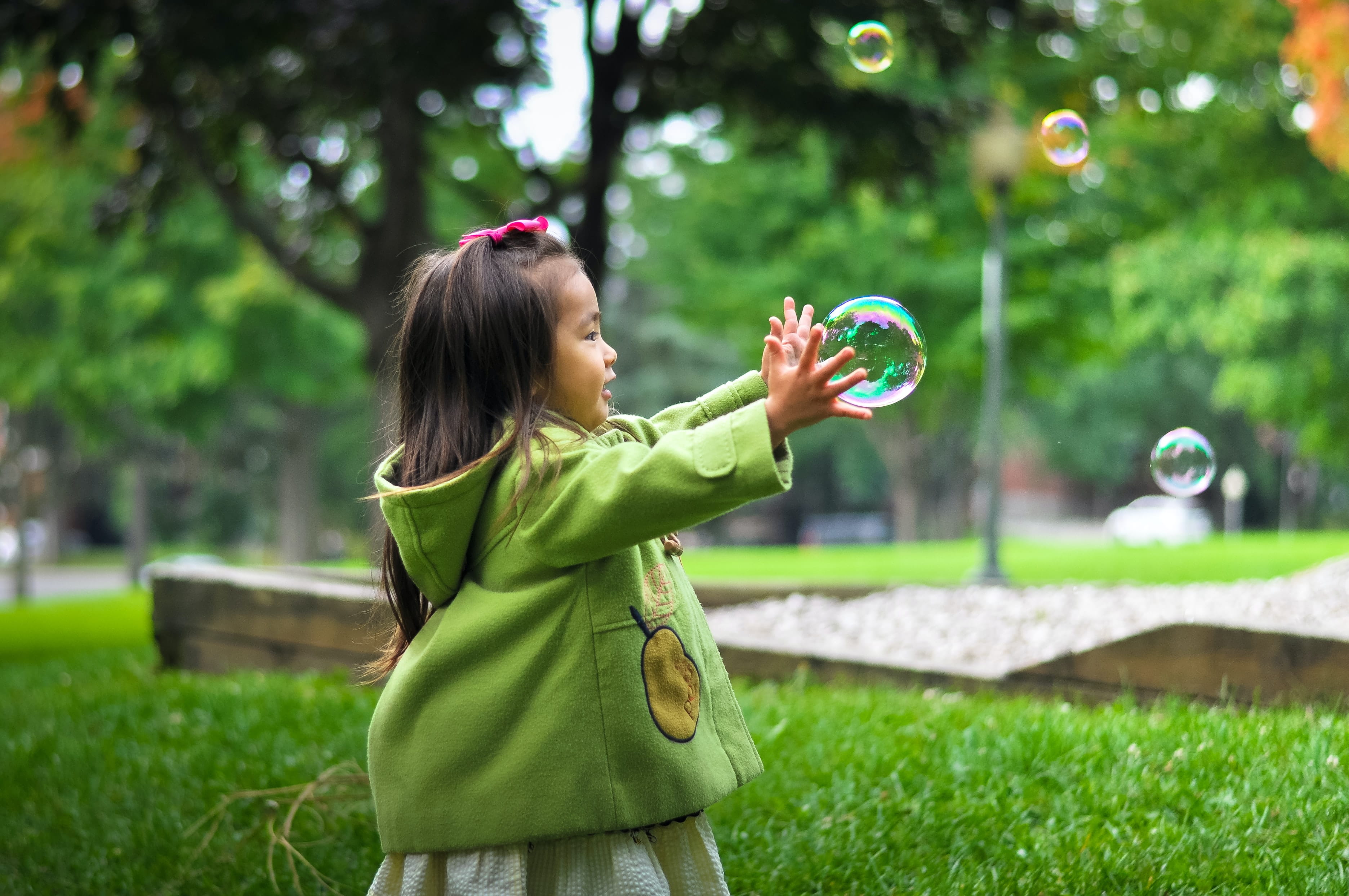 Photo of a little girl blowing bubbles