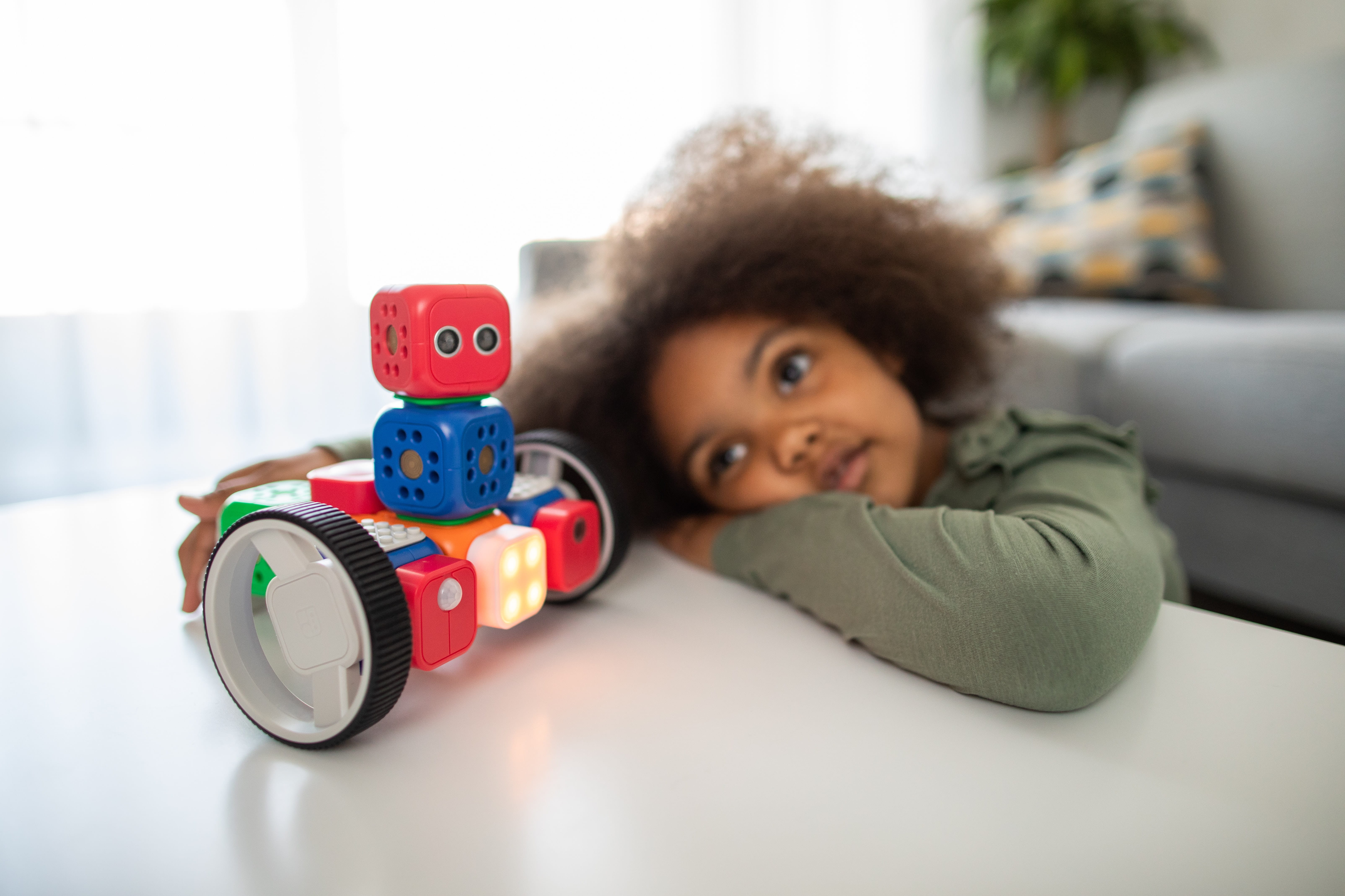 Photo of a child with a small robot toy
