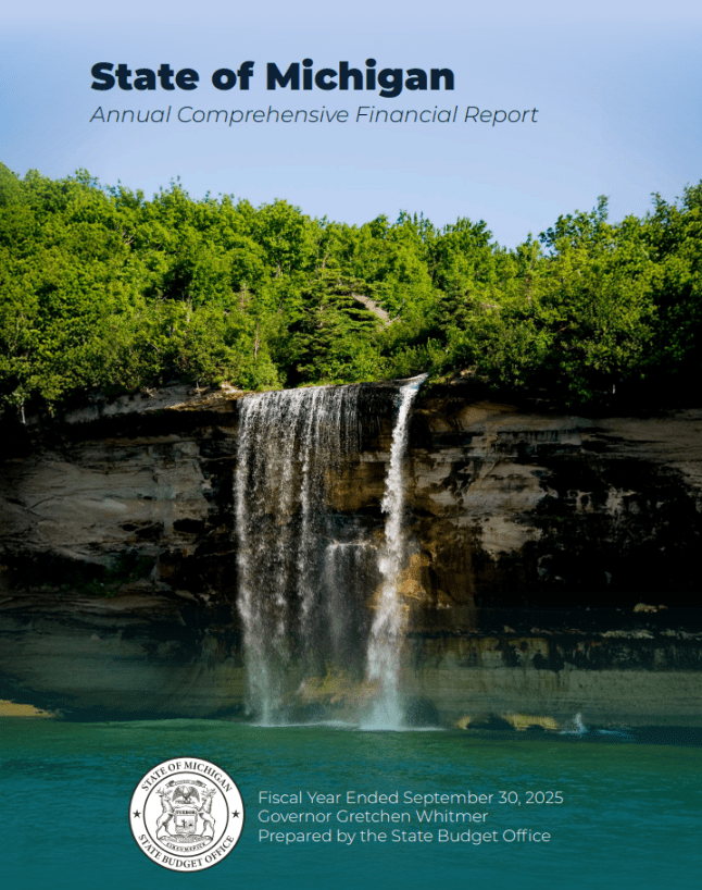 A waterfall cresting a cliff on the coast of Lake Superior's vibrant waters.