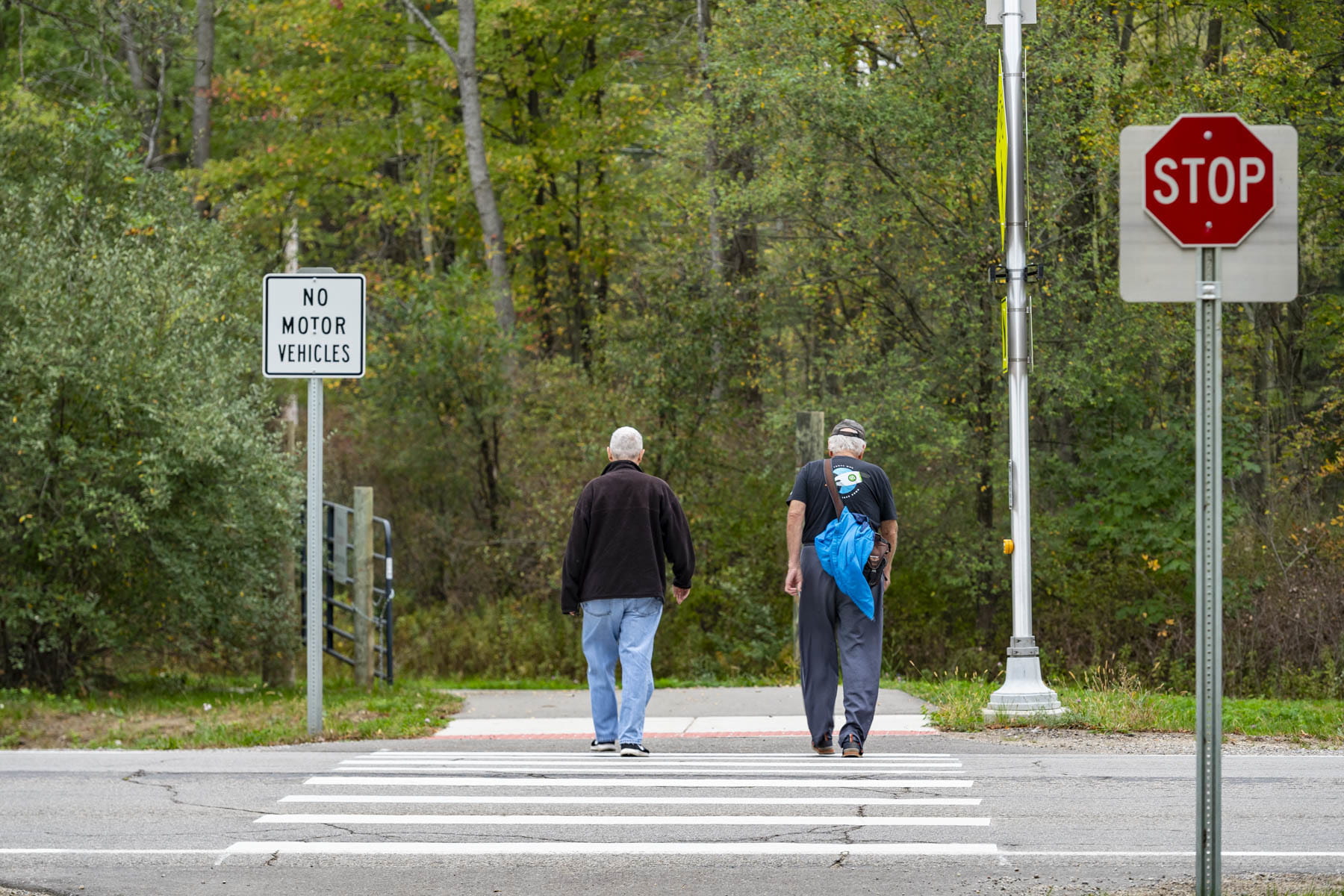 Two people walking on the Flint River Trail.