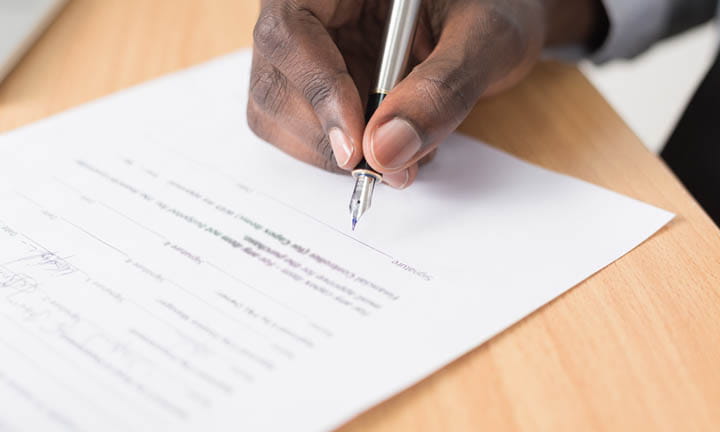 Hand signing papers