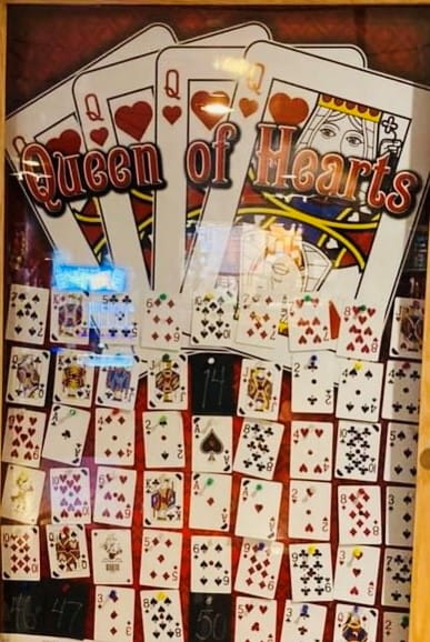 Progressive Card Raffle-Queen of Hearts Raffle glass locked display case with playing cards inside on display