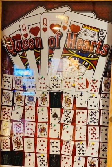 Progressive Card Raffle-Queen of Hearts Raffle glass locked display case with playing cards inside on display