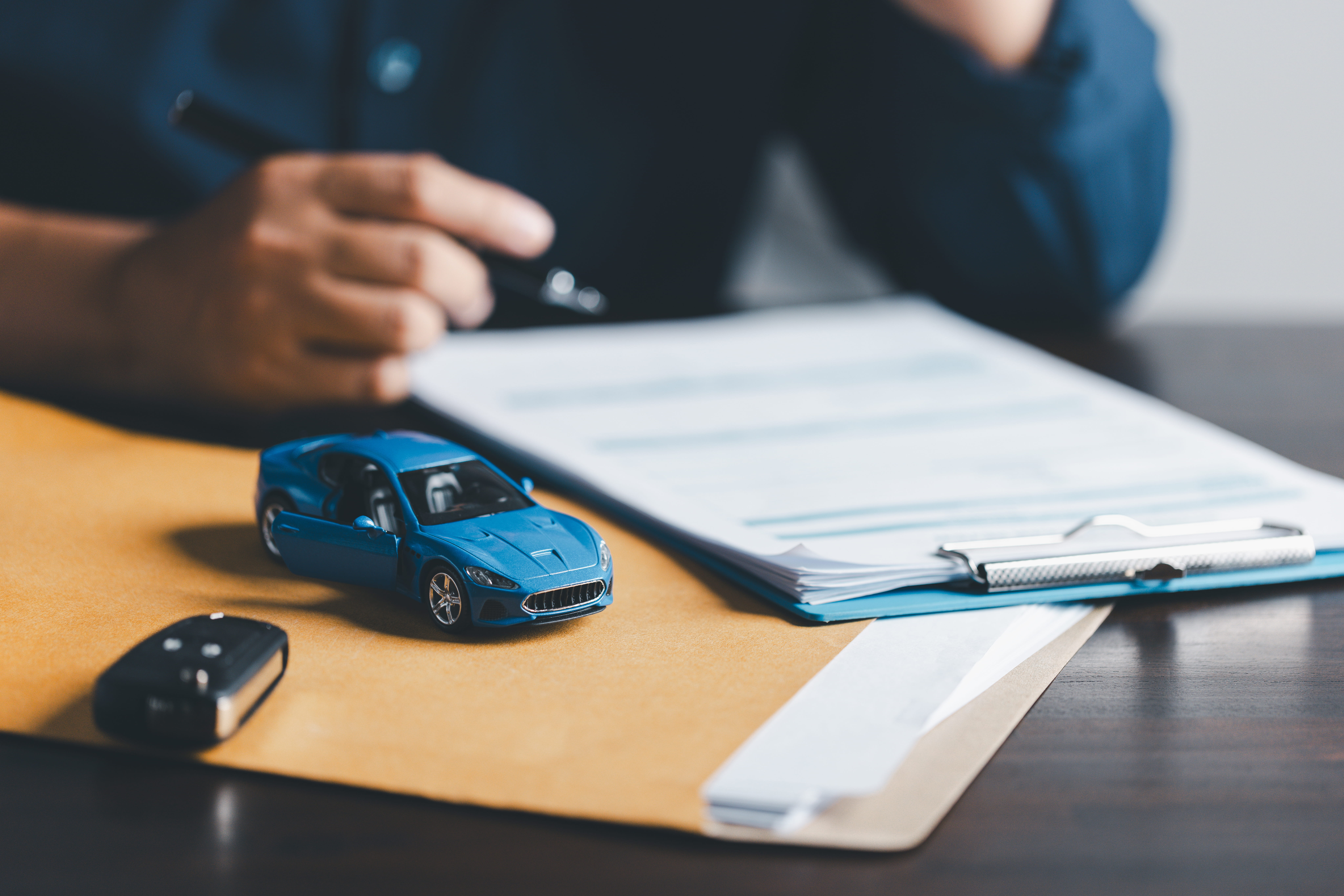 signing car insurance document or lease paper