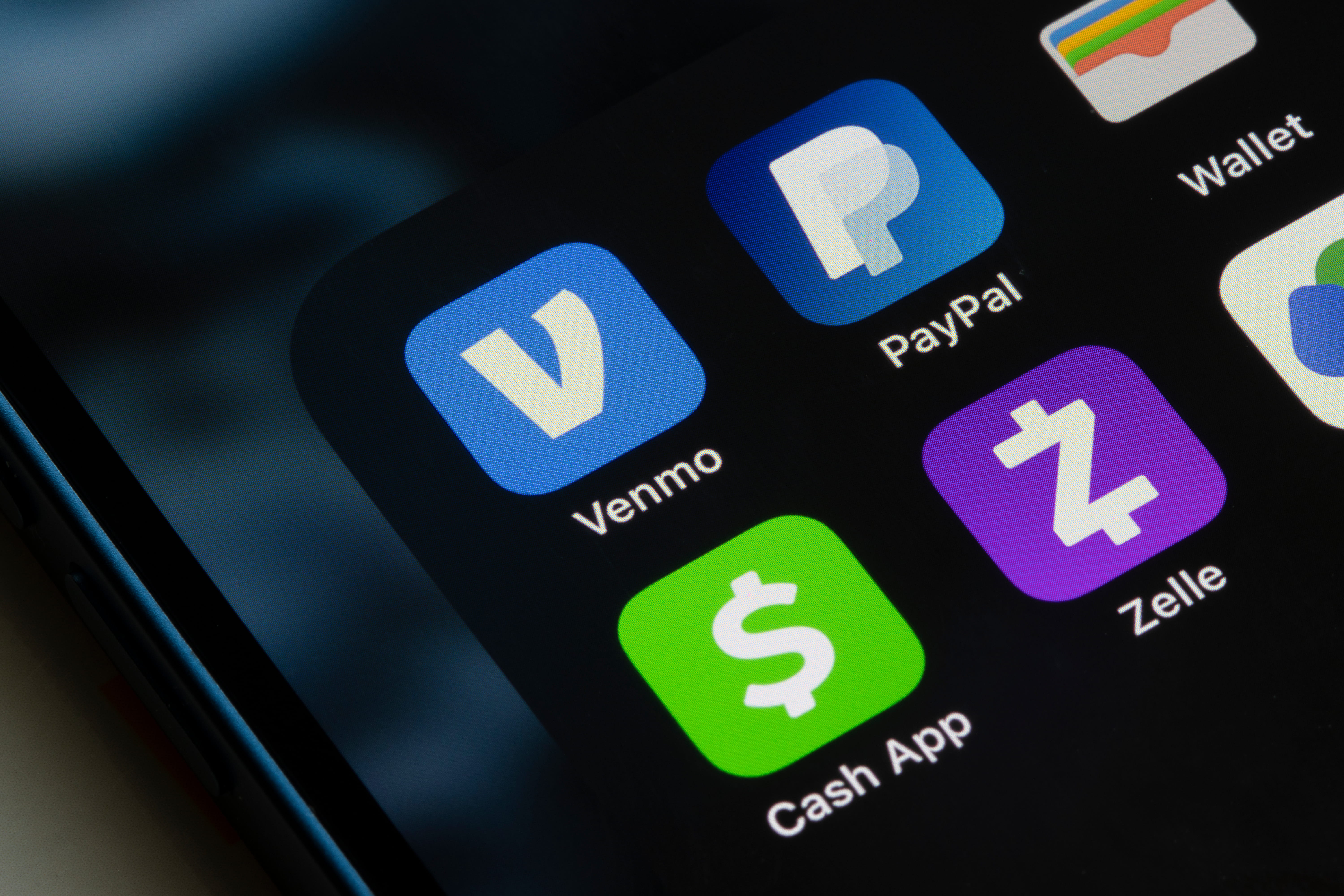 Venmo, PayPal, Cash App, and Zelle app icons are seen on an iPhone