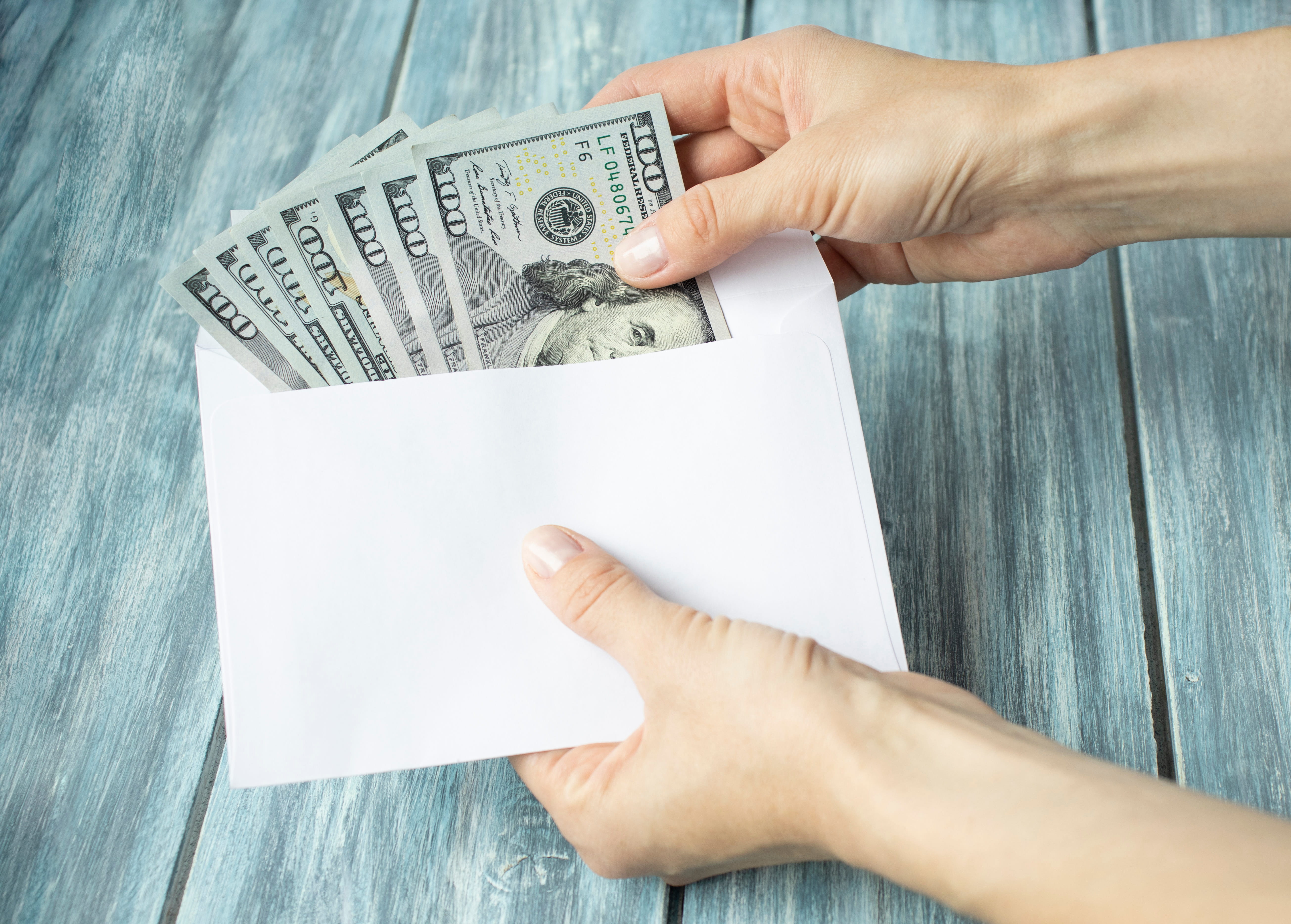 Hands Is Counting A Cash In An Envelope