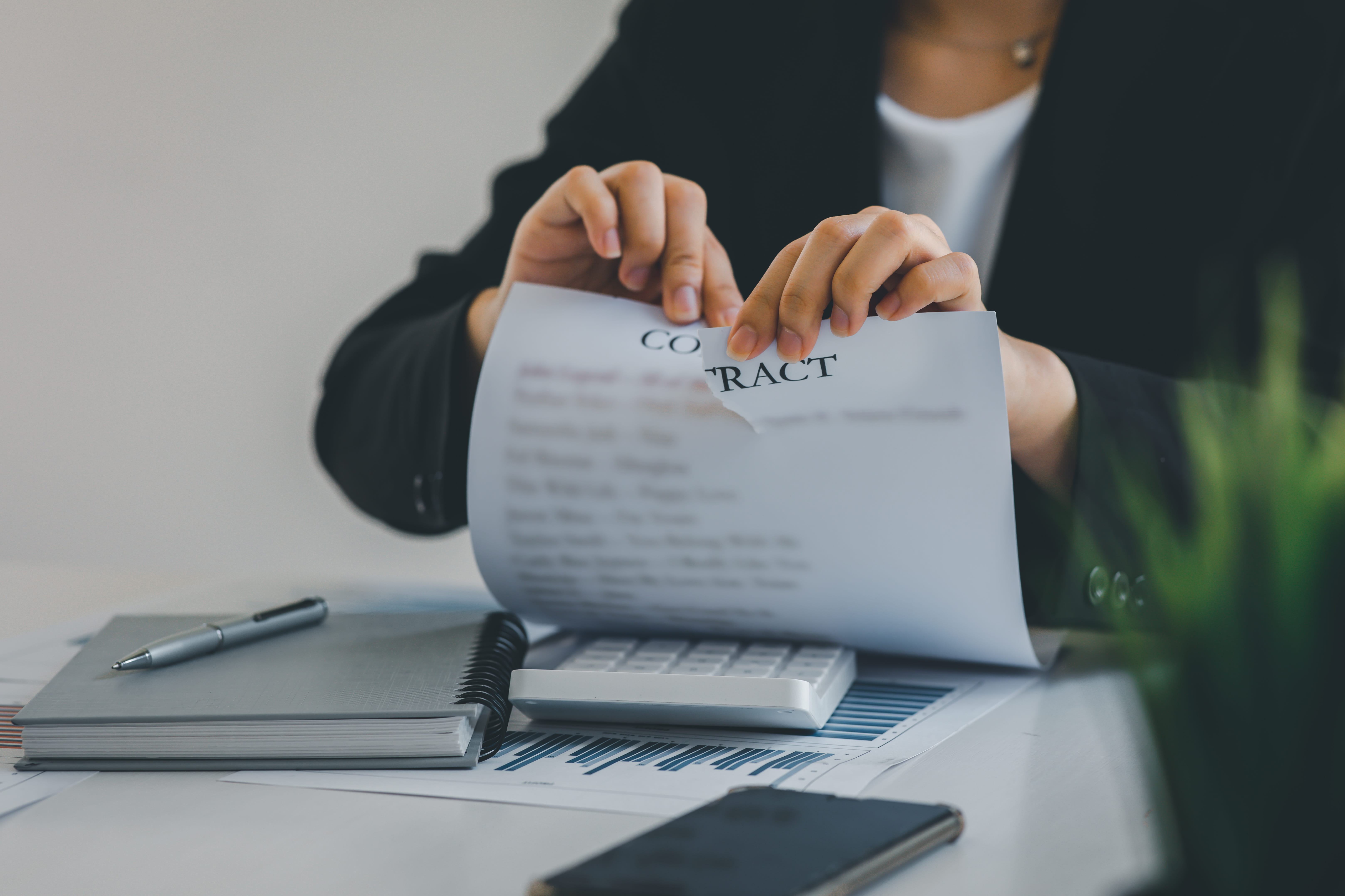 Young woman tearing up contract