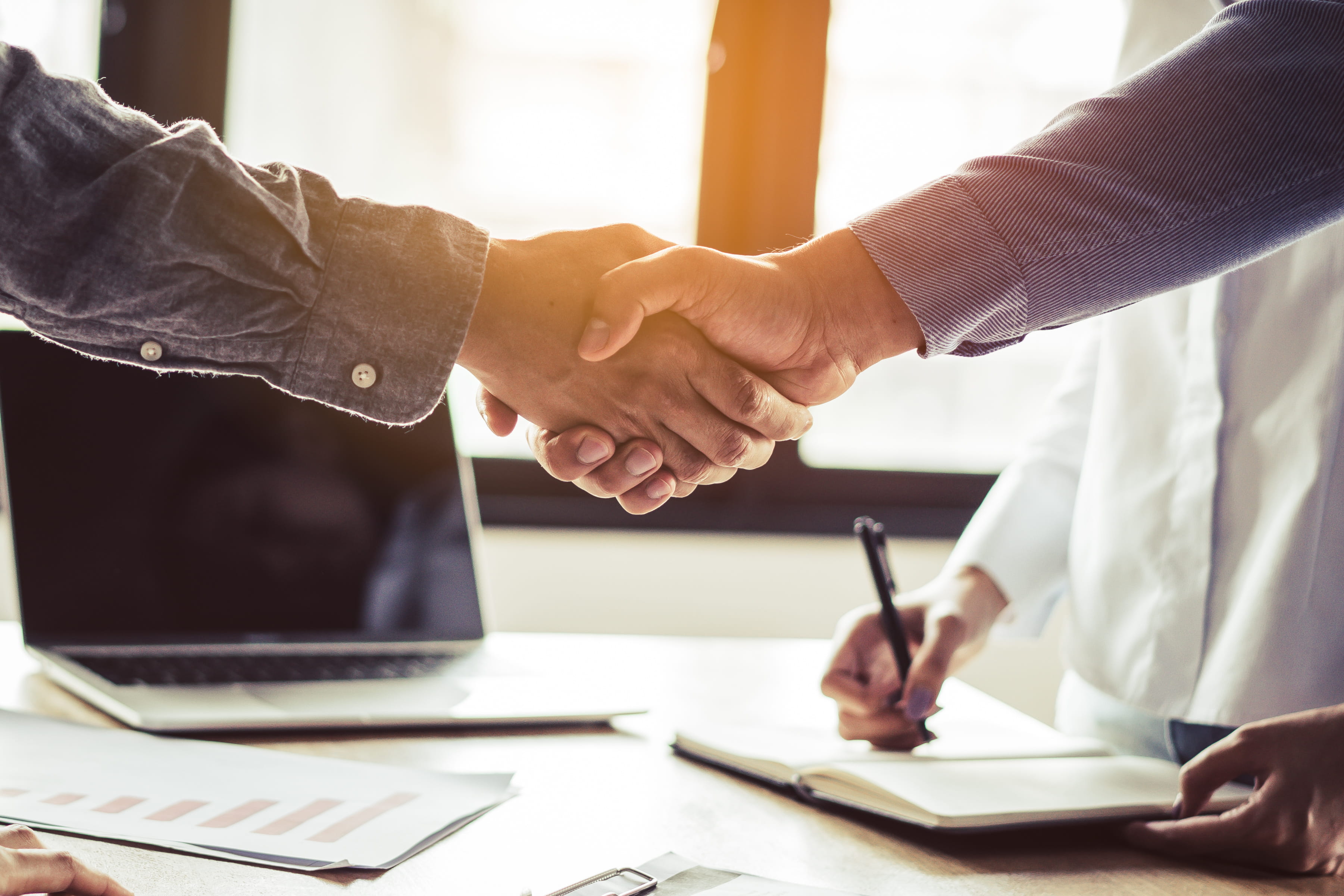 Two businessmen handshaking after the contract was signed.