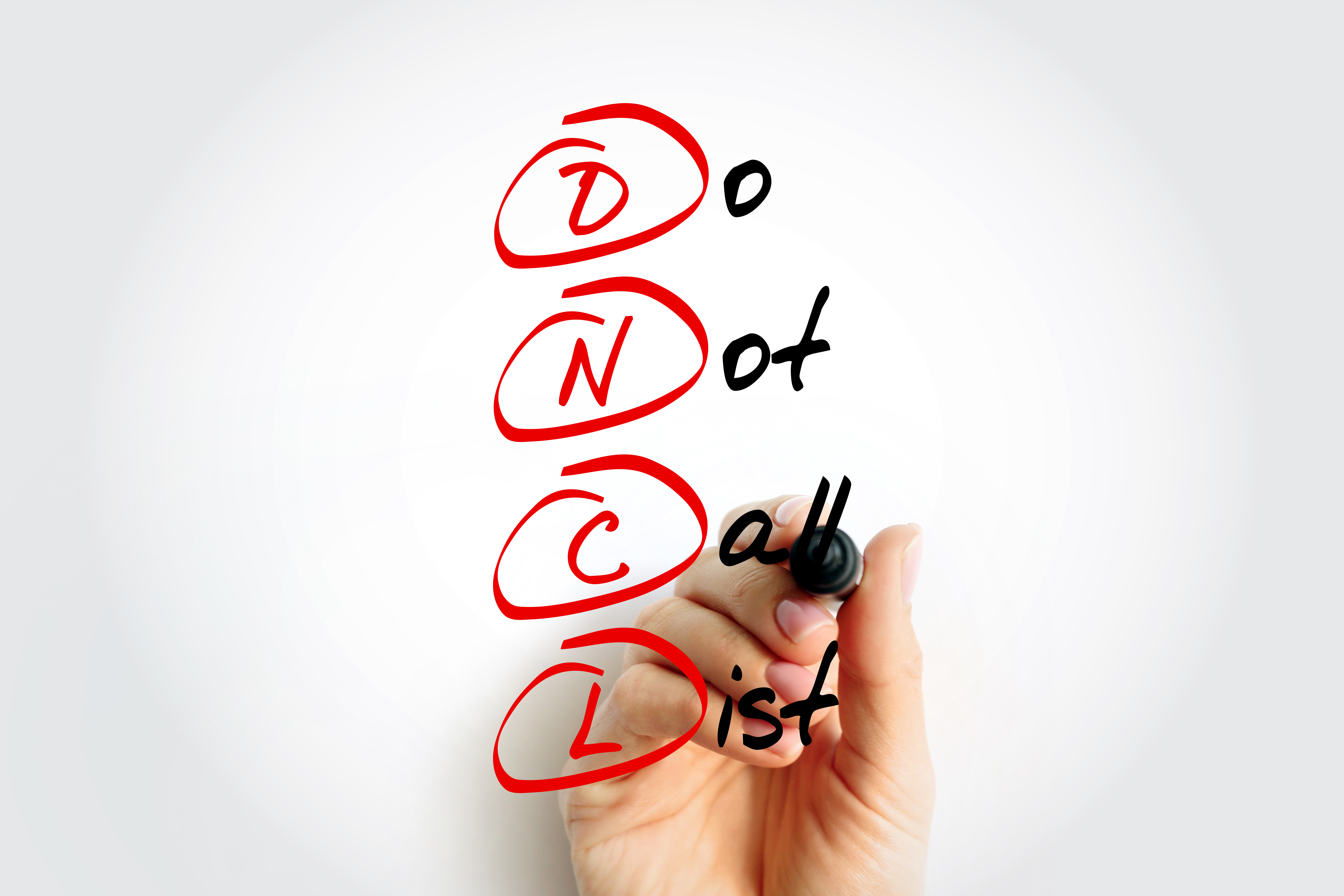 Person writing out and circling the Do Not Call List