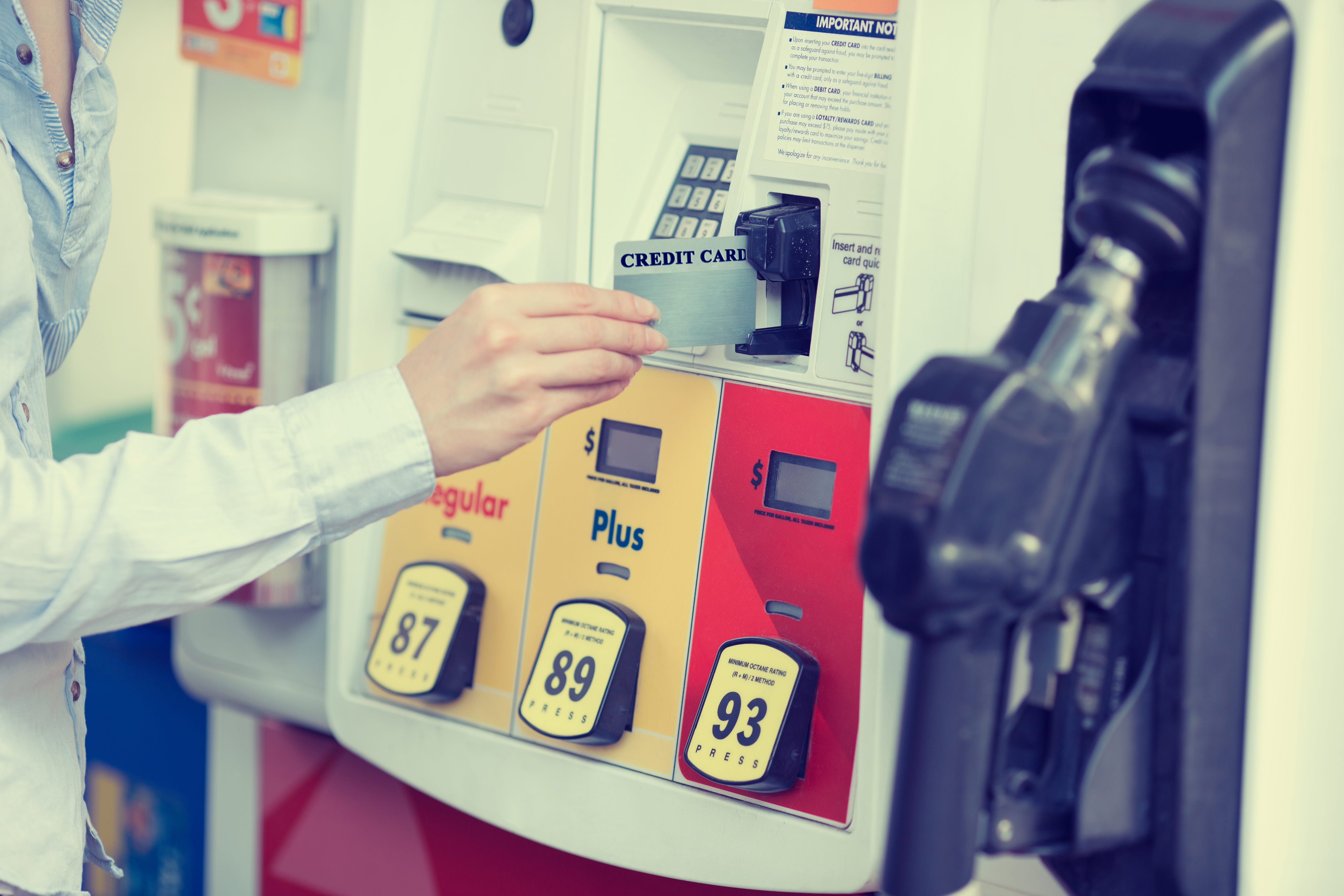 Person paying by card at the gas pump