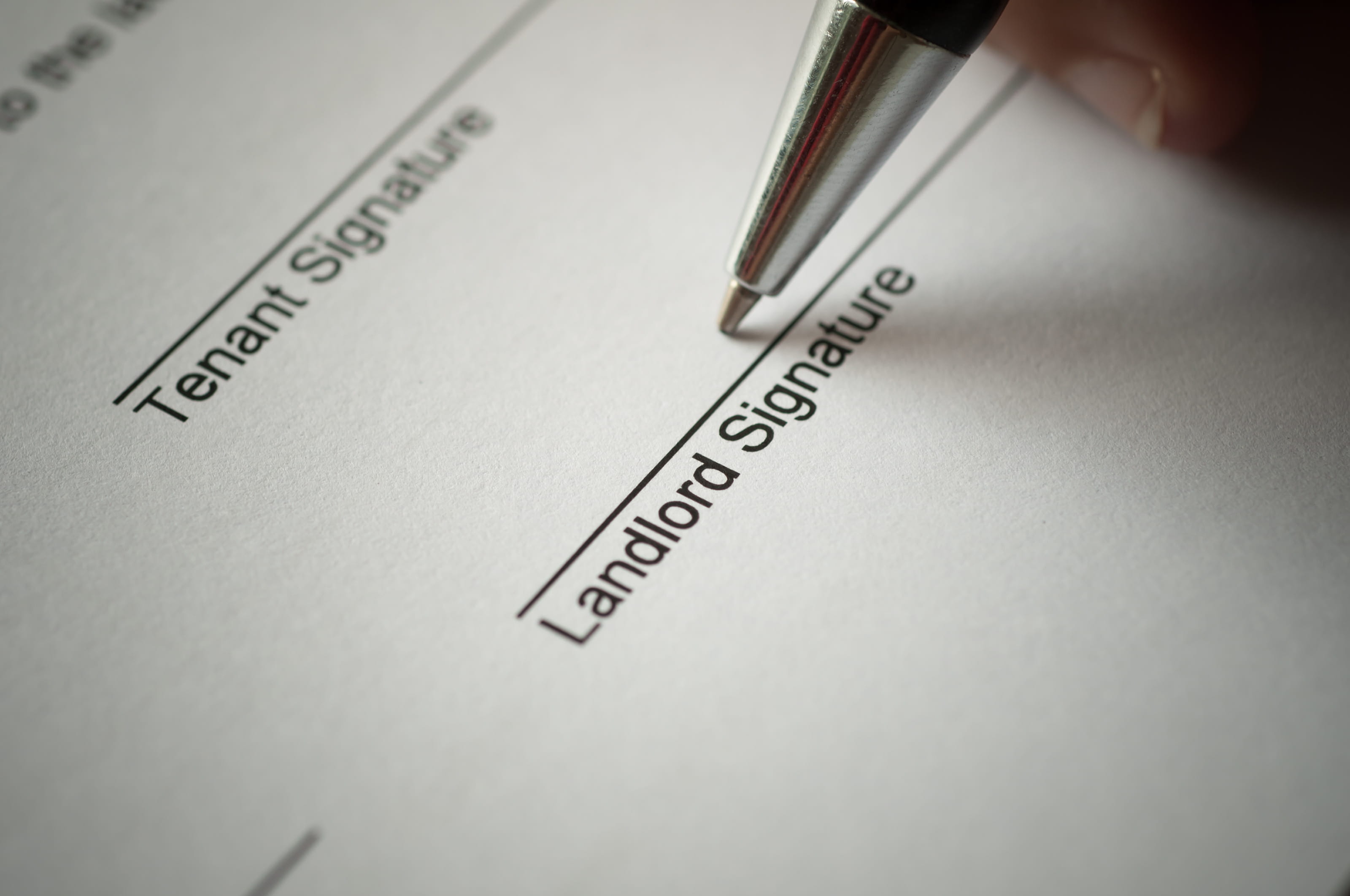 Landlord signing a rental agreement