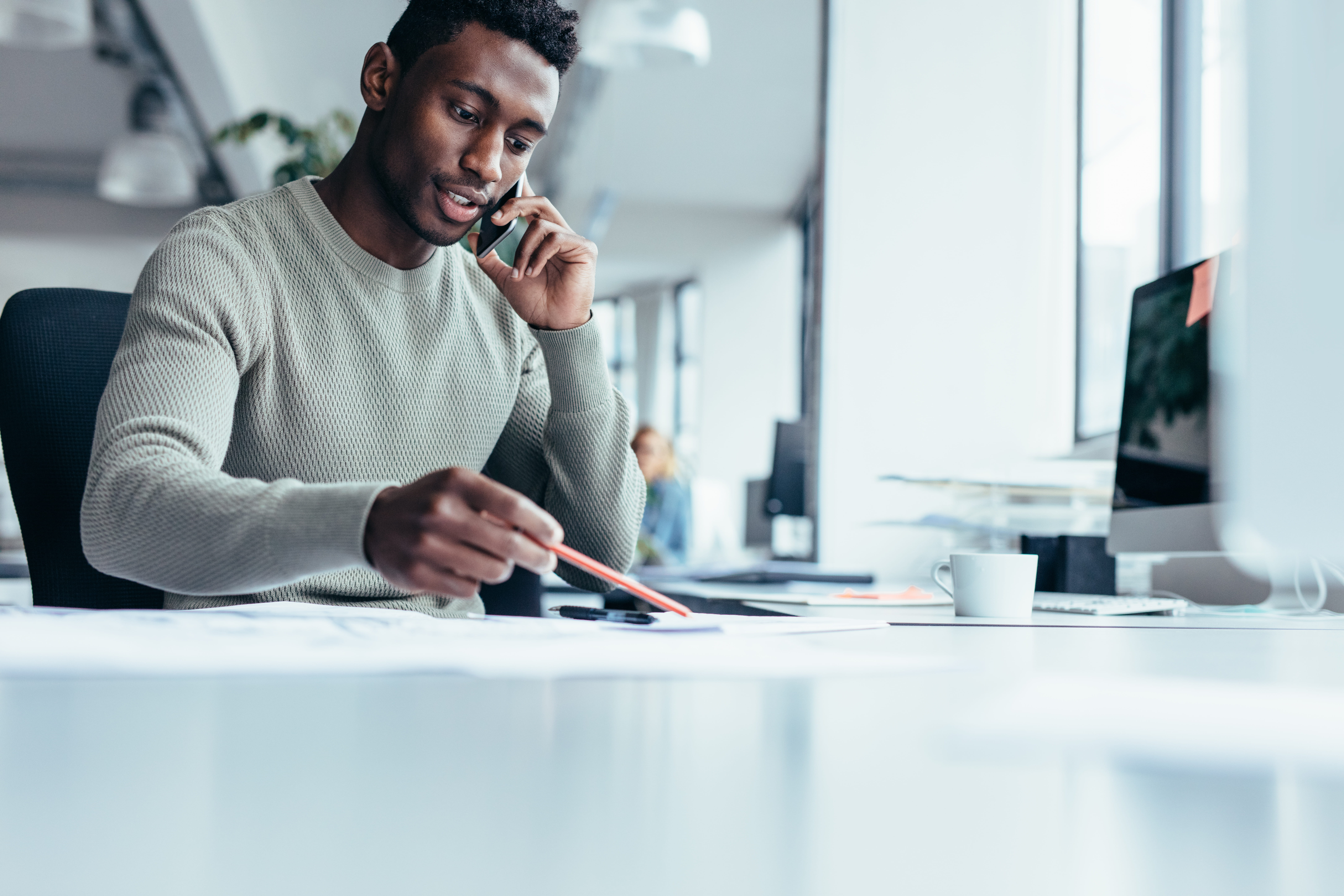 Black male taking phone call at work
