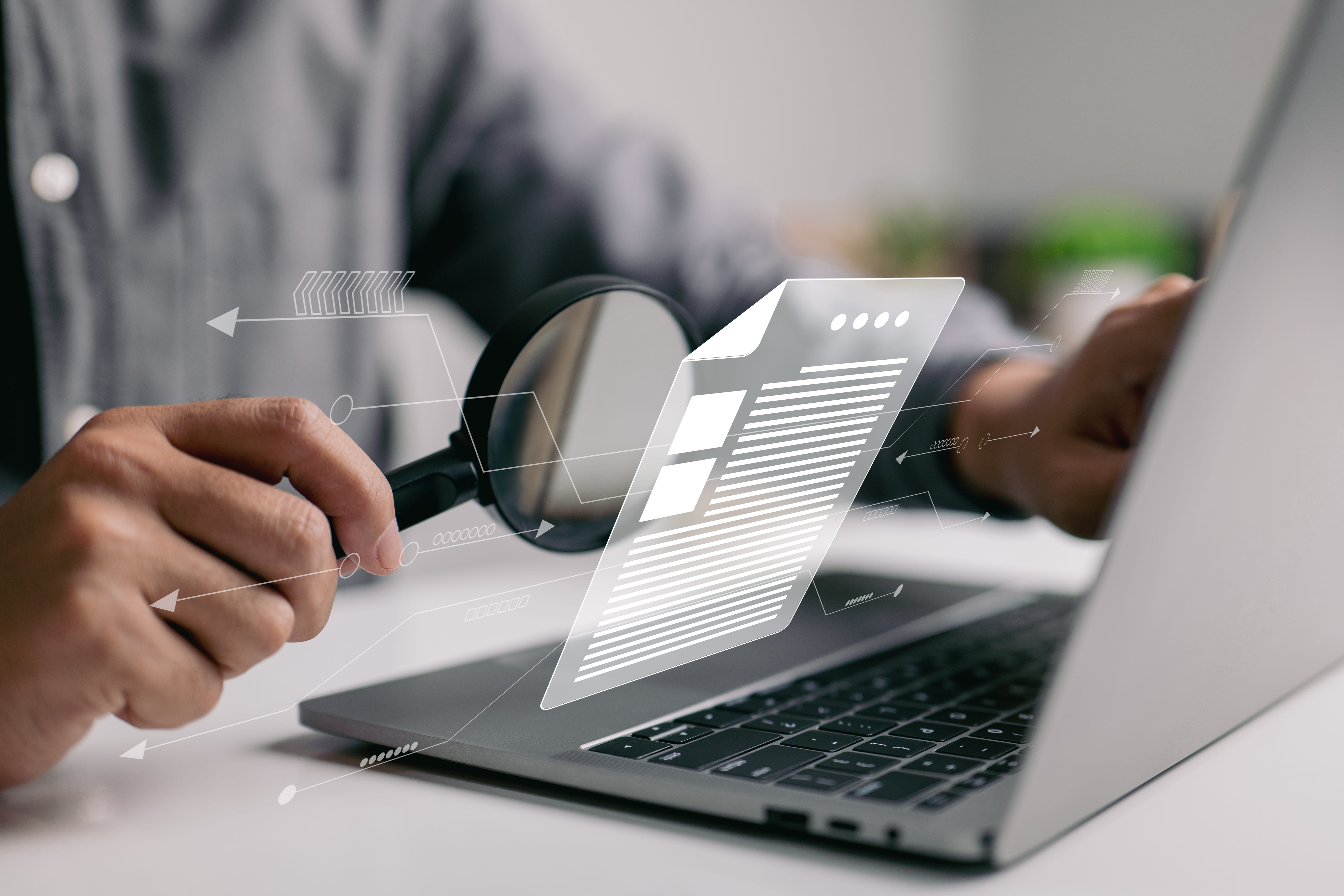 Man inspecting paperwork with magnifier