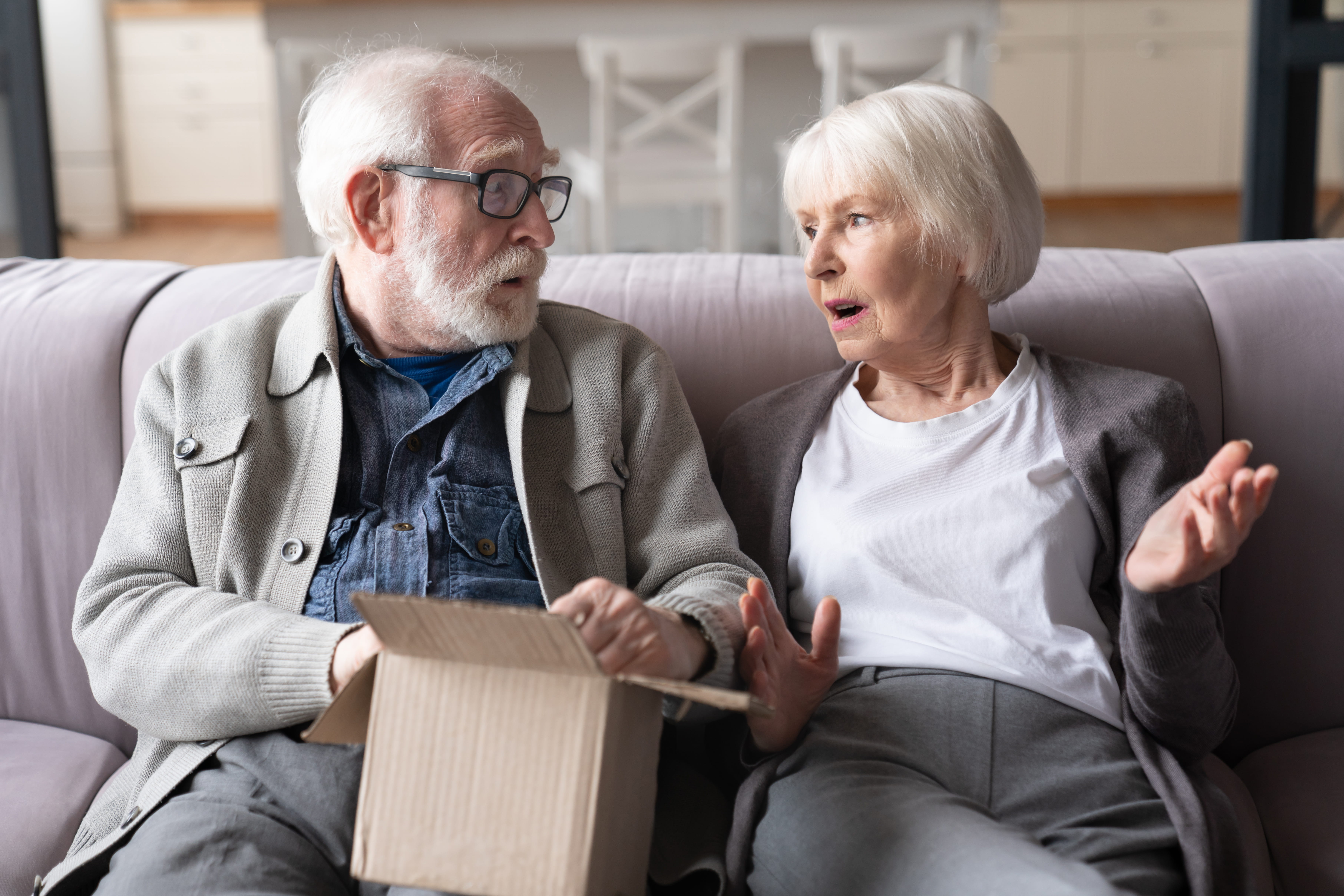 Shocked angry disappointed stressed senior elderly old grandparents family spouses receiving wrong parcel,