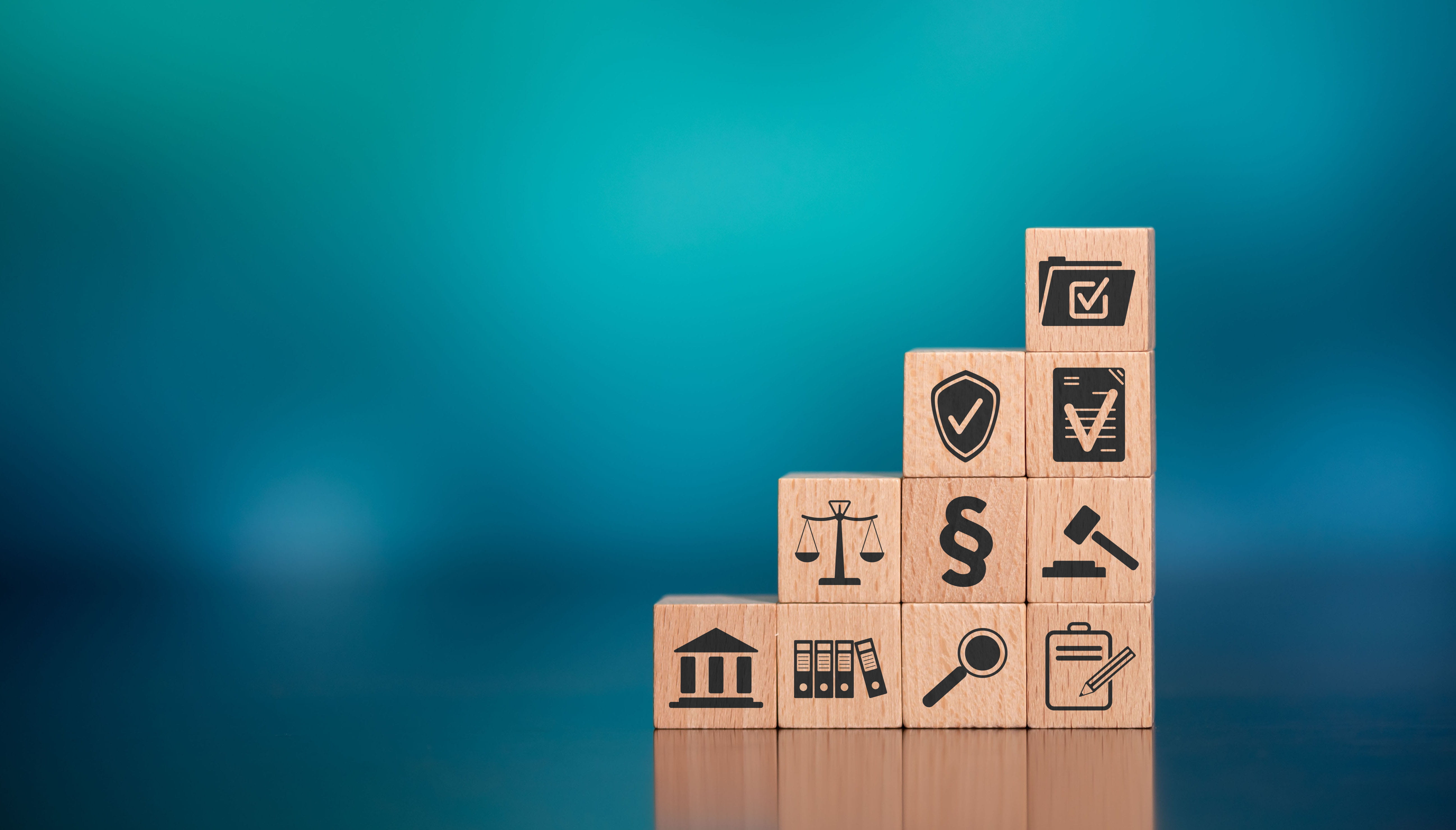 wooden blocks with icons showing compliance, laws, rules, guidelines, and filingd laws