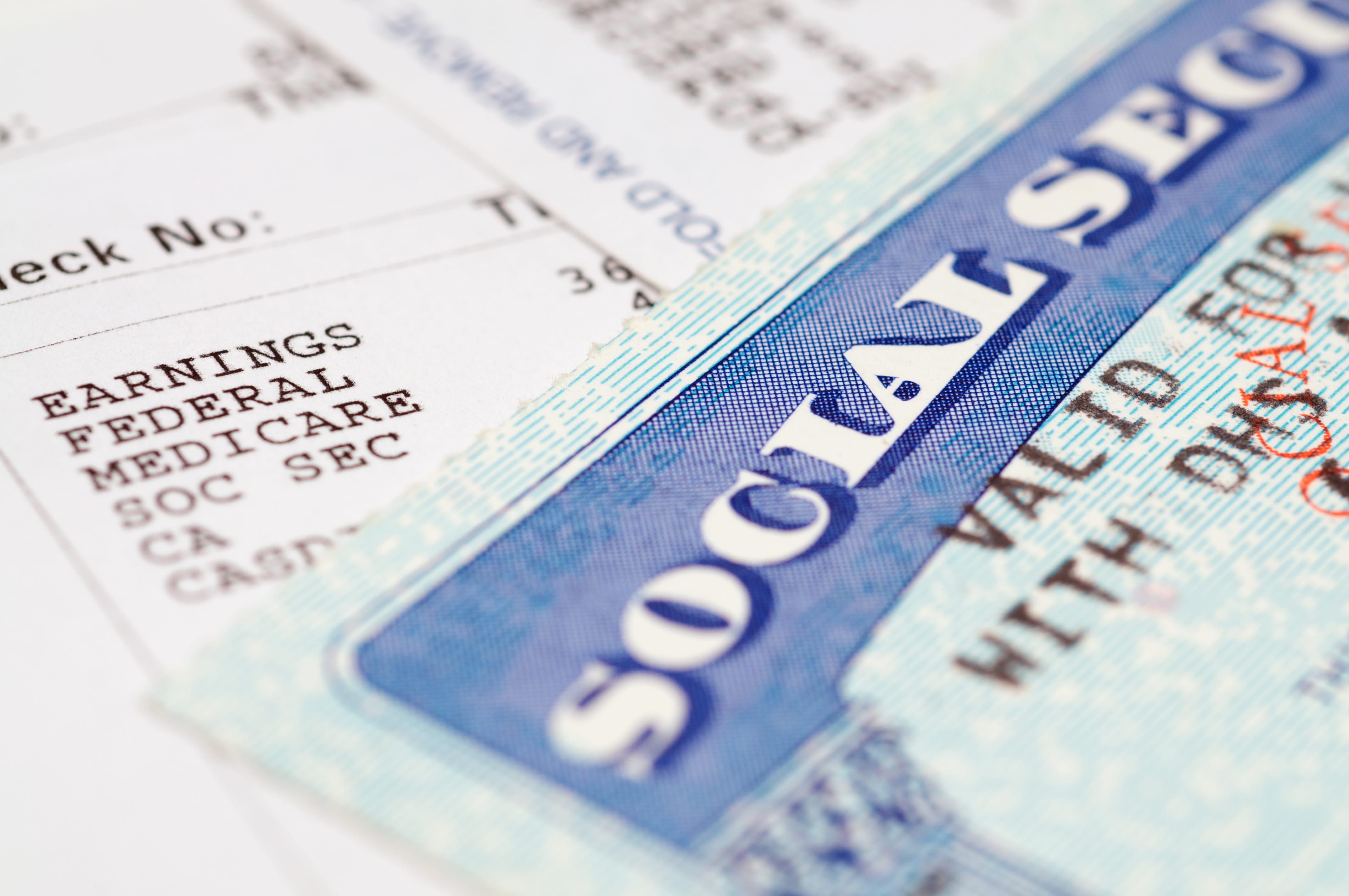 Social security card on top of a pile papers