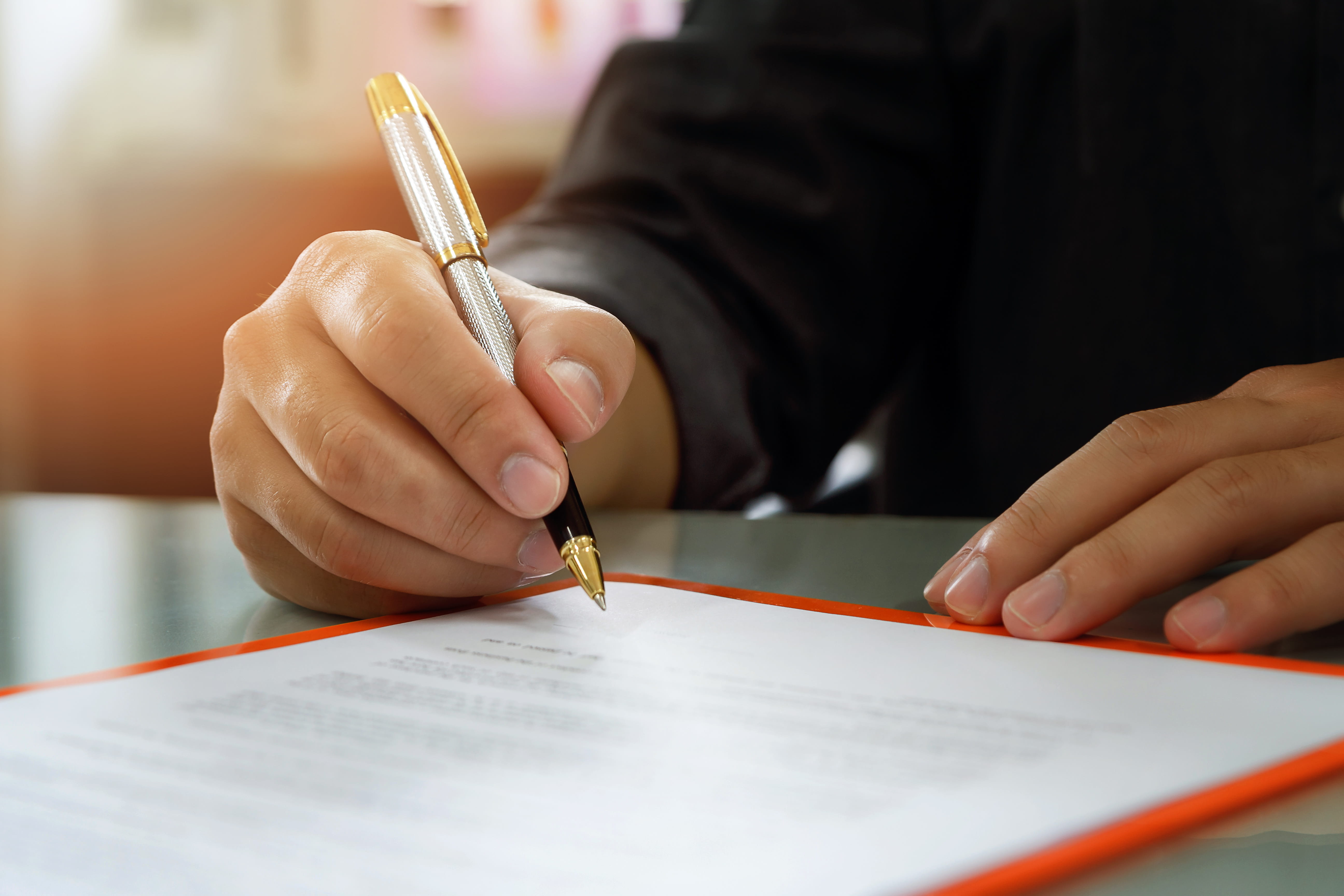 Close up of business man signing contract