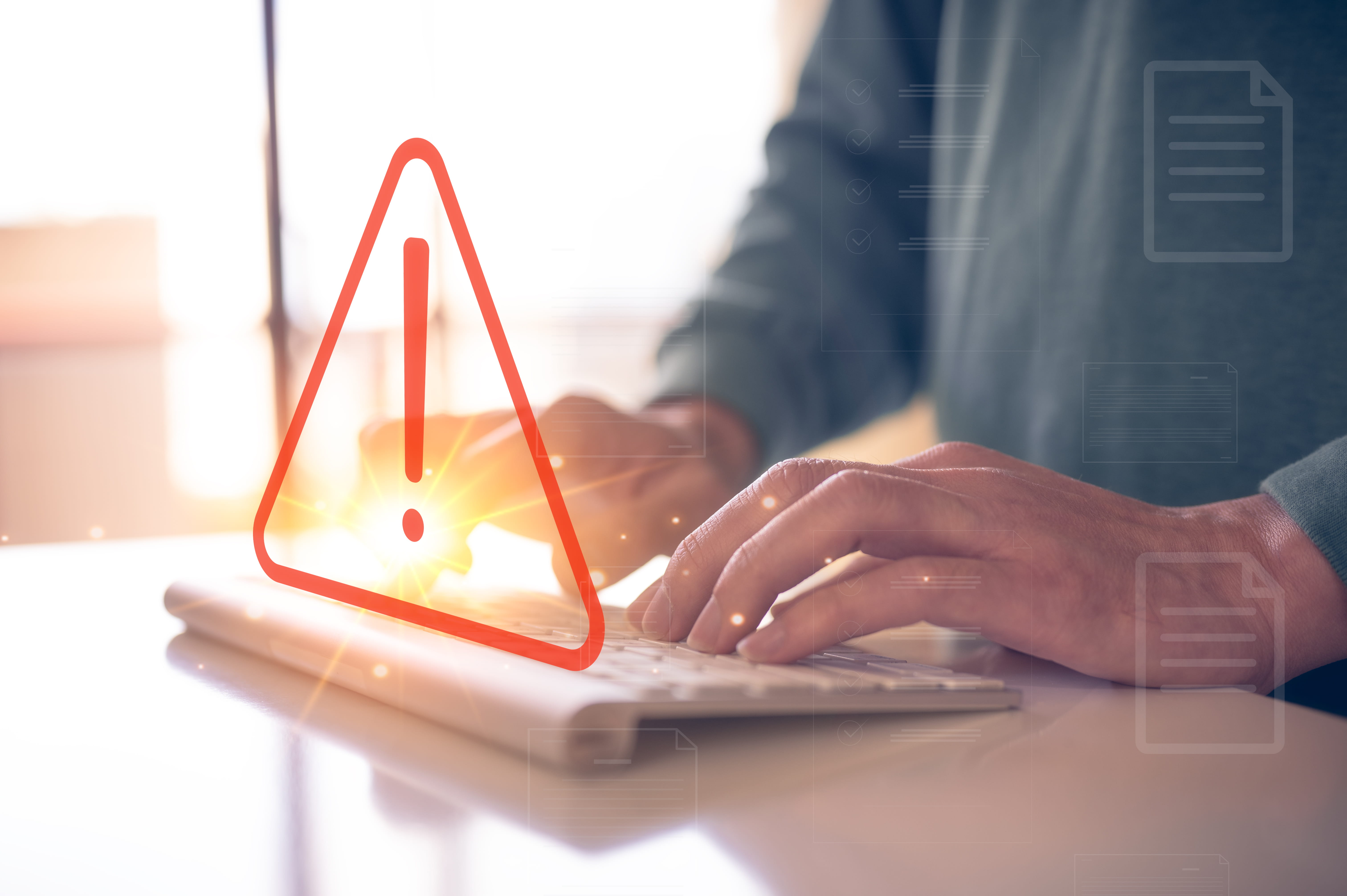 man typing on keyboard with triangle warning sign developer with triangle caution warning sign for notification error