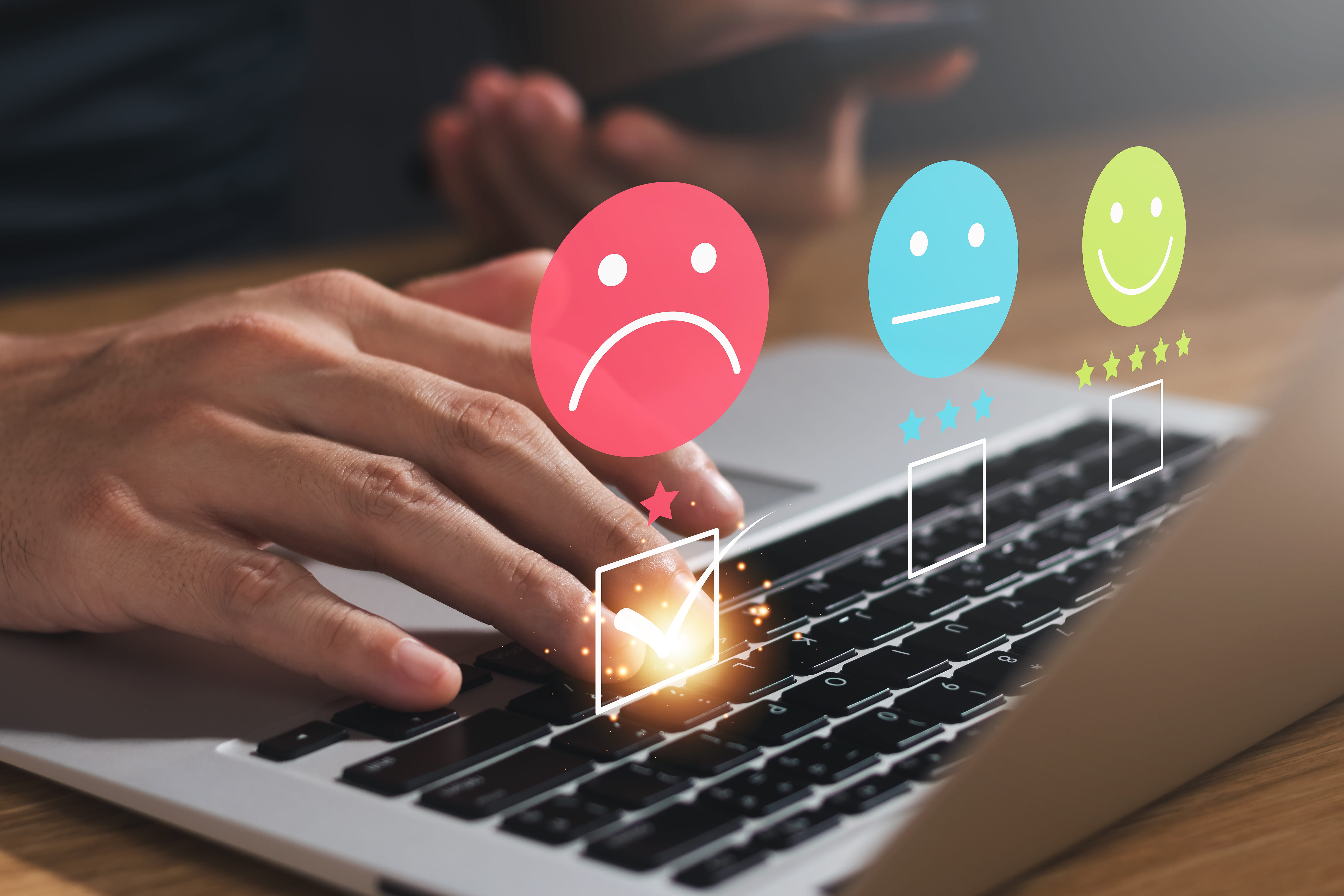 person using laptop to complete online complaint form. The box to show dissatisfaction is checked; next to the neutral and happy icons.