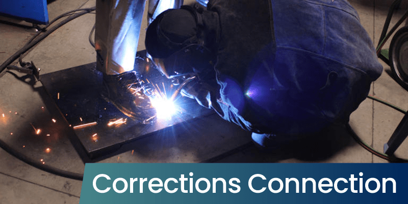 A prisoner welding the feet of a metal statue with the text "Corrections Connection" placed over the image.