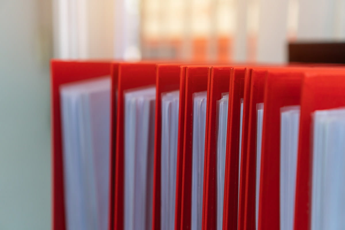 Filing folders with paperwork inside of each folder.